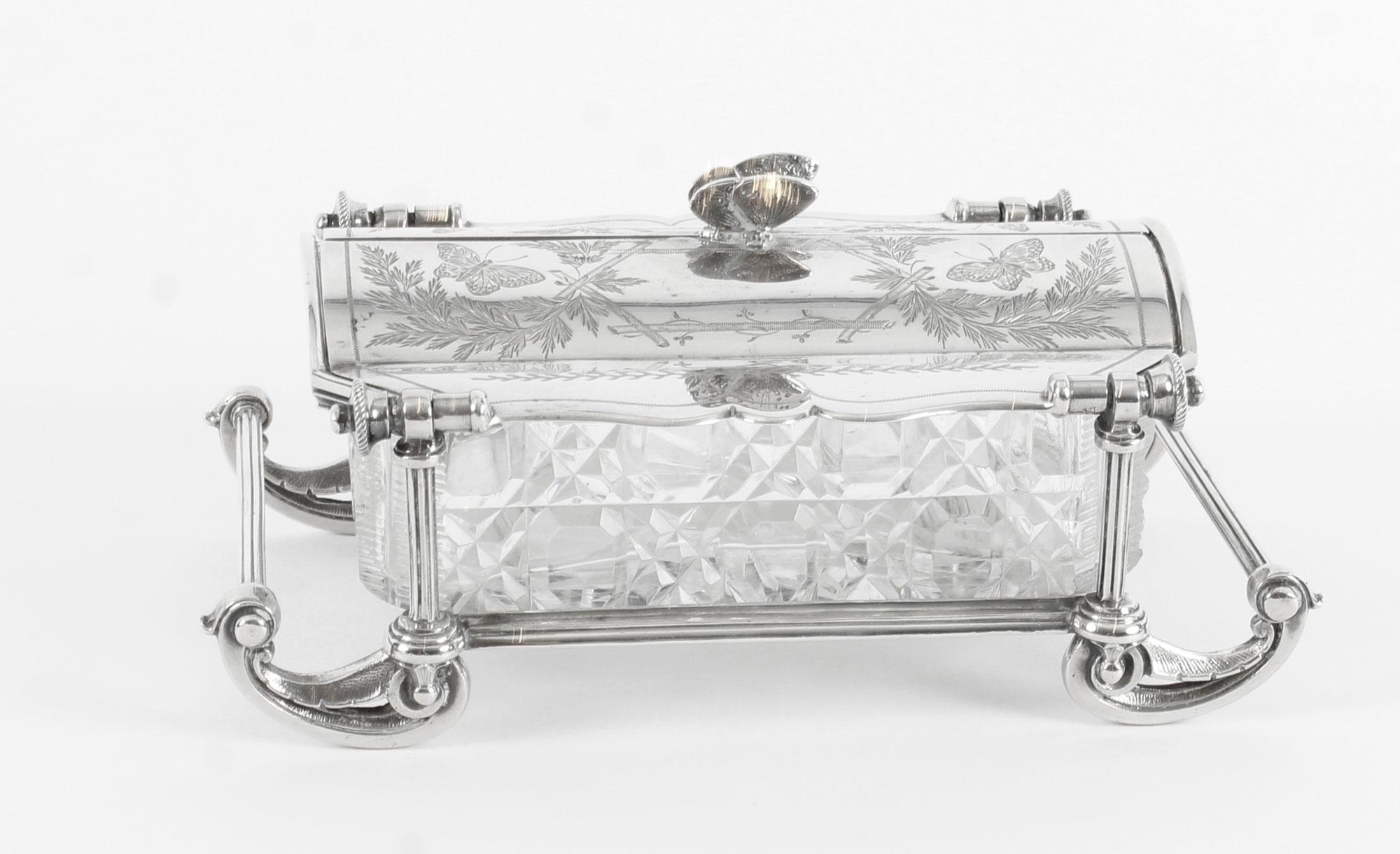 This is a fine antique English Victorian silver plated and cut glass butter dish, with the maker's mark of the renowned silversmith and retailer, Elkington & Co and a date stamp for 1890.

The two door lift up lid is engraved with floral and