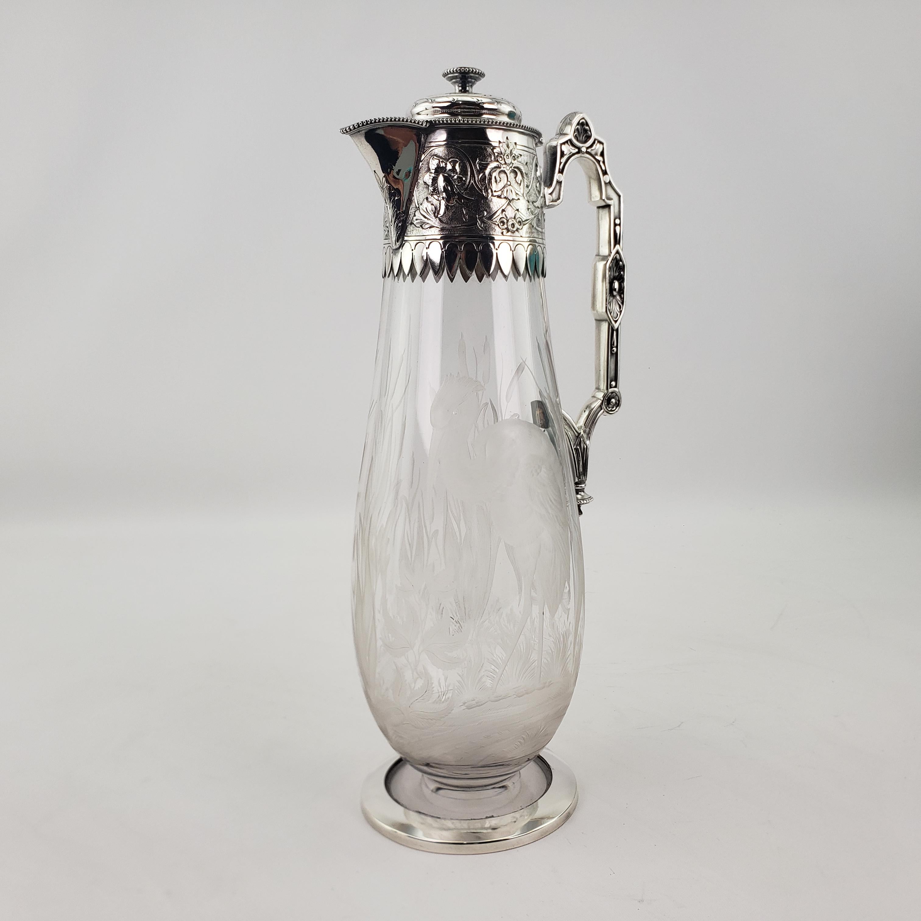 This very well executed engraved crystal and silver plated claret jug is hallmarked by the renowned Elkington & Co. of England and dating to approximately 1880 in the period Victorian style. This claret jug has highly detailed cast and silver plated