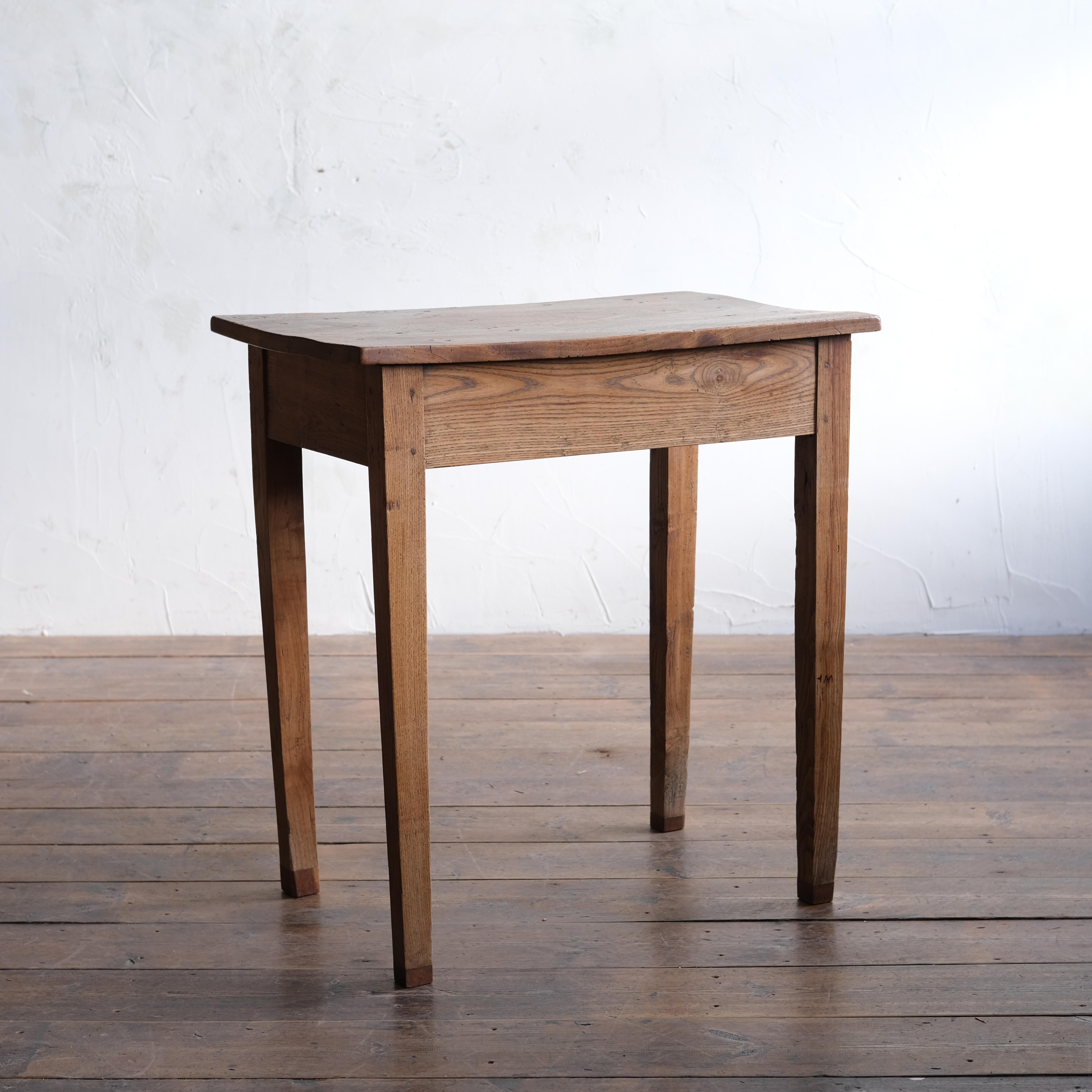 A characterful elm side table with single piece elm top. It seems someone may have used it at some point as a dining table as pieces have been added to give it height, they can be removed if needed. 
47cm deep

72cm wide

78cm high

62cm knee
