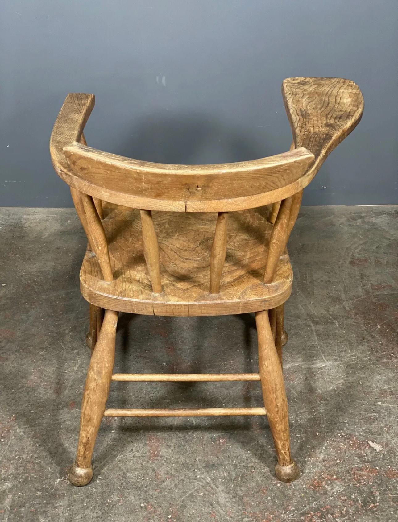 Early 20th Century Antique Elm Smokers Bow Captains Chair With Oversized Arm For Sale