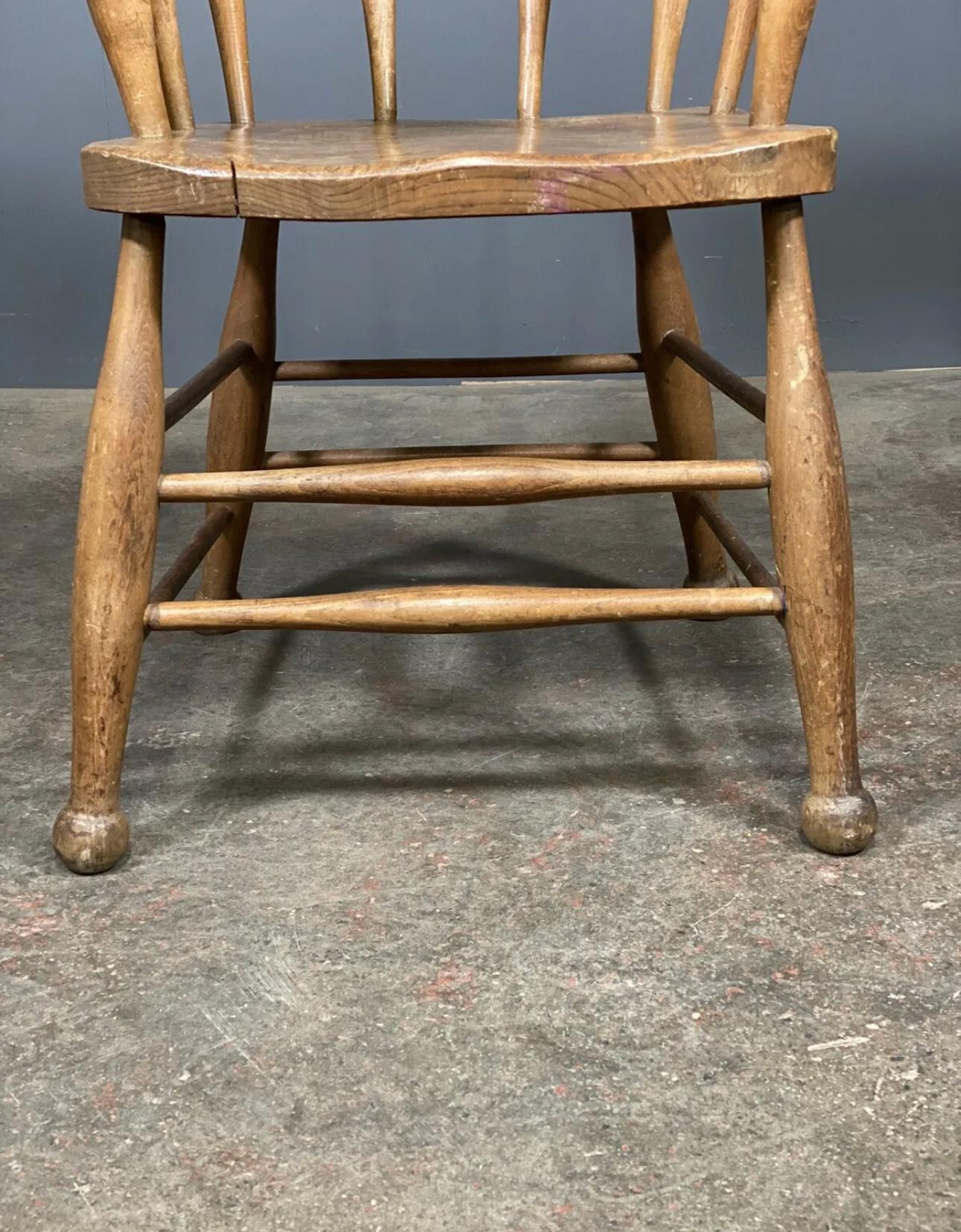 British Antique Elm Smokers Bow Captains Chair With Oversized Arm For Sale