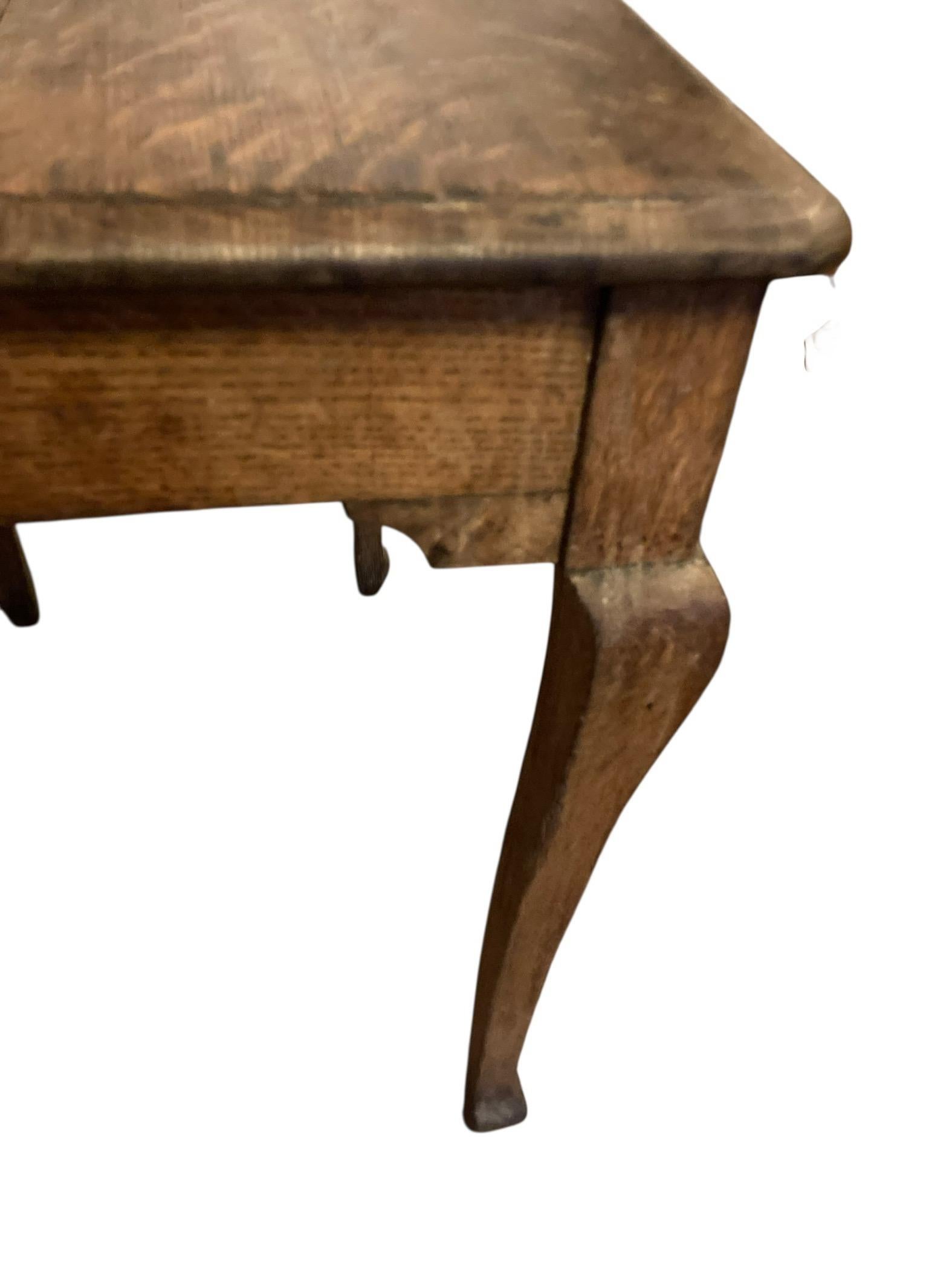 Antique Elm Wood Side or Occassional table early 1900's raised on Cabriole legs. Can be used as hall table, end table or desk. This unusual design has no drawers. Very good solid condition.

H: 76cm

Leg H: 66cm

W: 75cm

D: 50cm