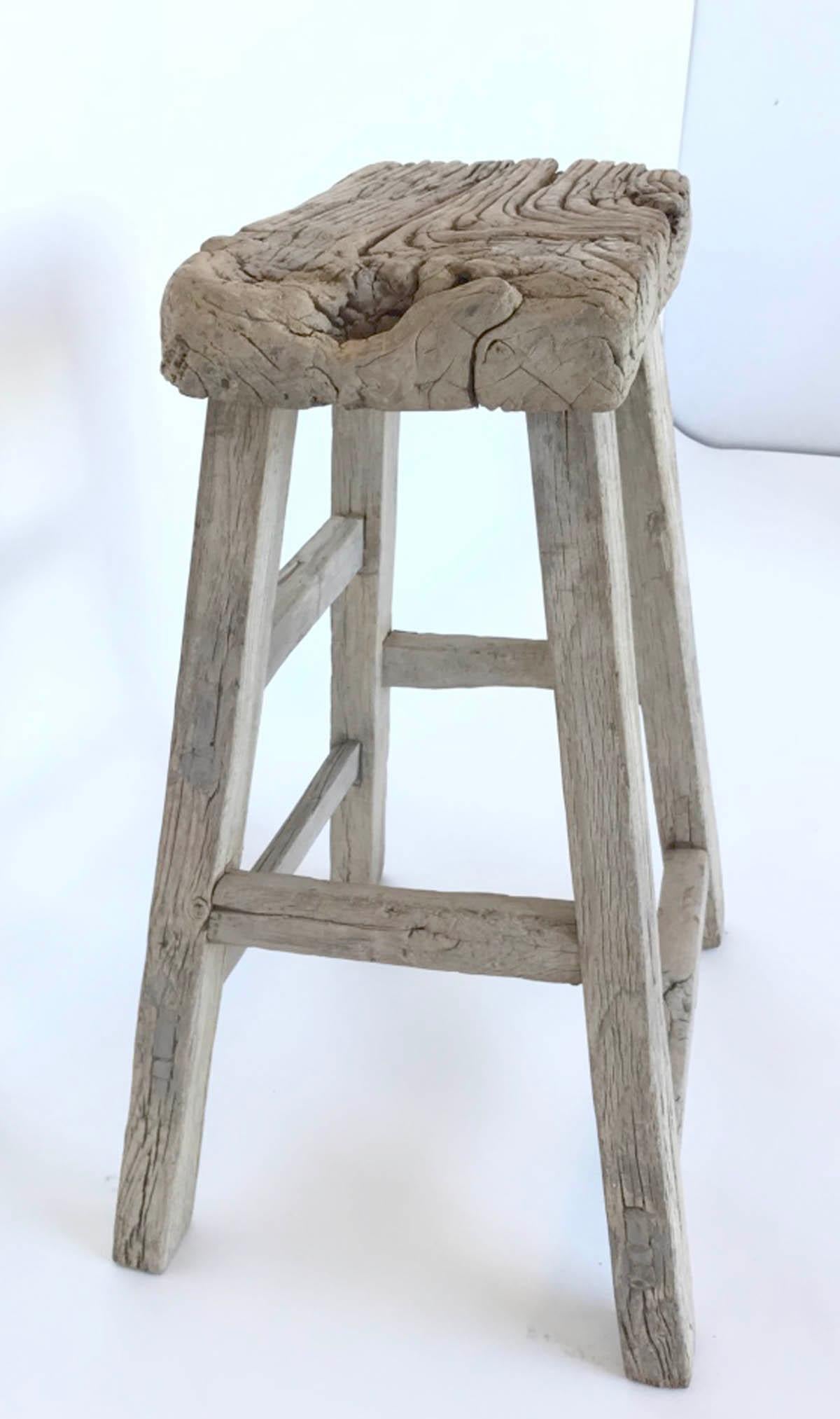 Naturally worn and aged Japanese elmwood stool in grey and beige hues. The footprint measures 24.5 x 19. Mortise and tenon stretcher. The seat is 2.5 inches thick. Great as a plant stand, side table or single stool. Height can be modified if needed.
