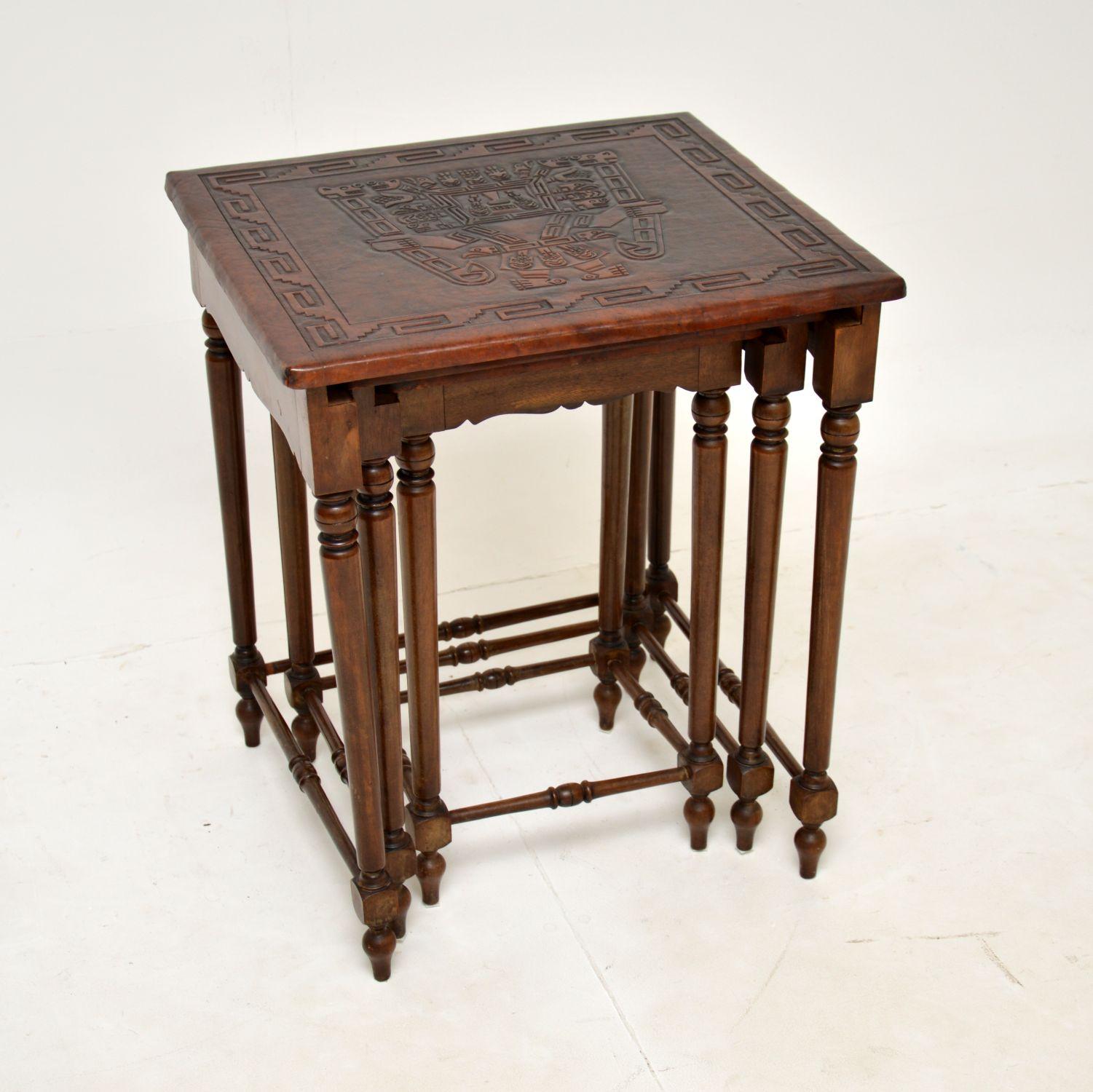 A very interesting antique embossed leather top nest of tables, made in England & dating from around the 1910 period.

The leather tops depict Aztec or possibly Inca gods, they have exceptional details and are extremely well made. The frames are