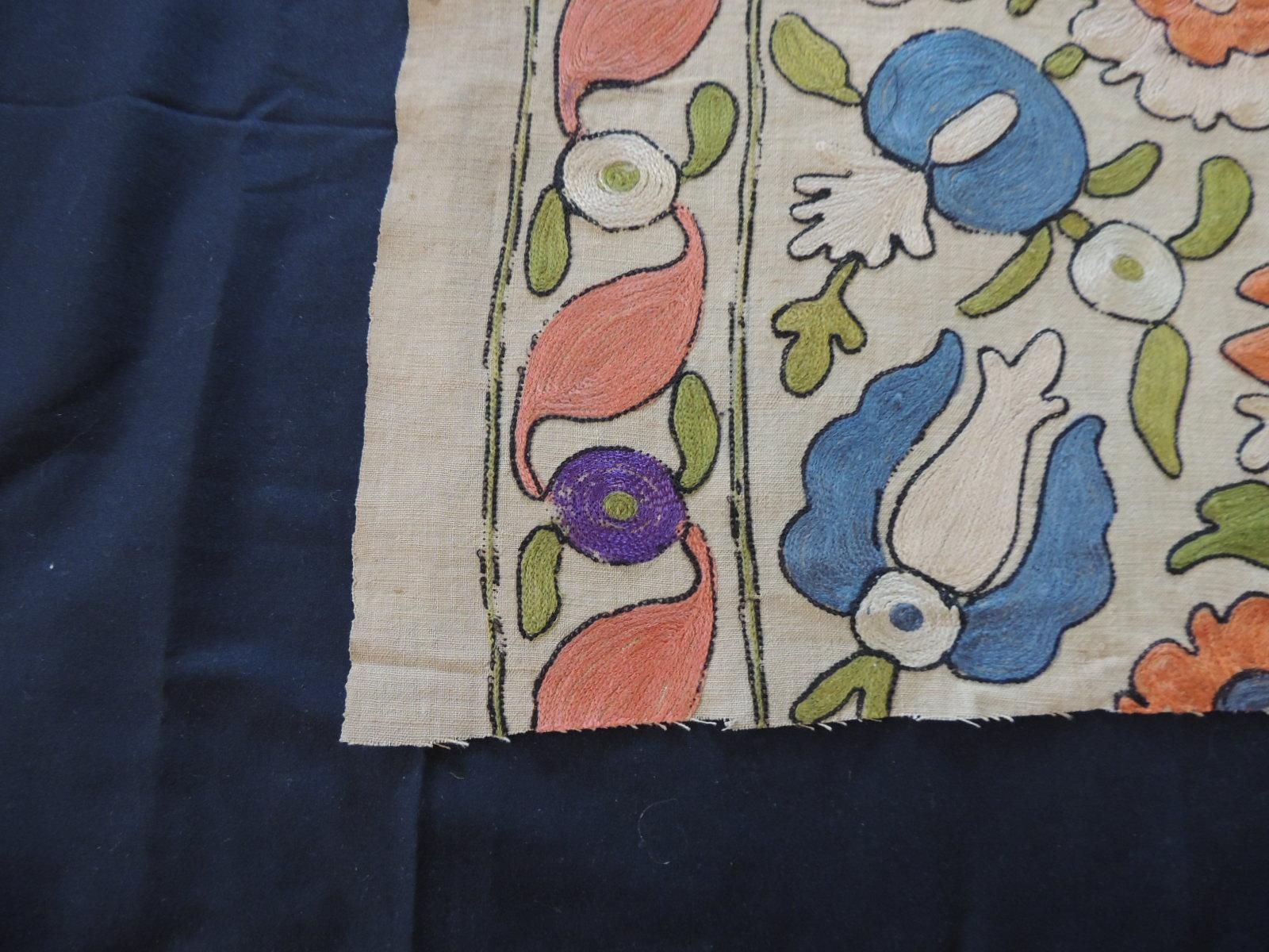 Antique embroidered floral silk Suzani textile fragment.
In shades of orange, natural, blue, red, yellow and green.
Ideal to make a pillow.
Size: 16