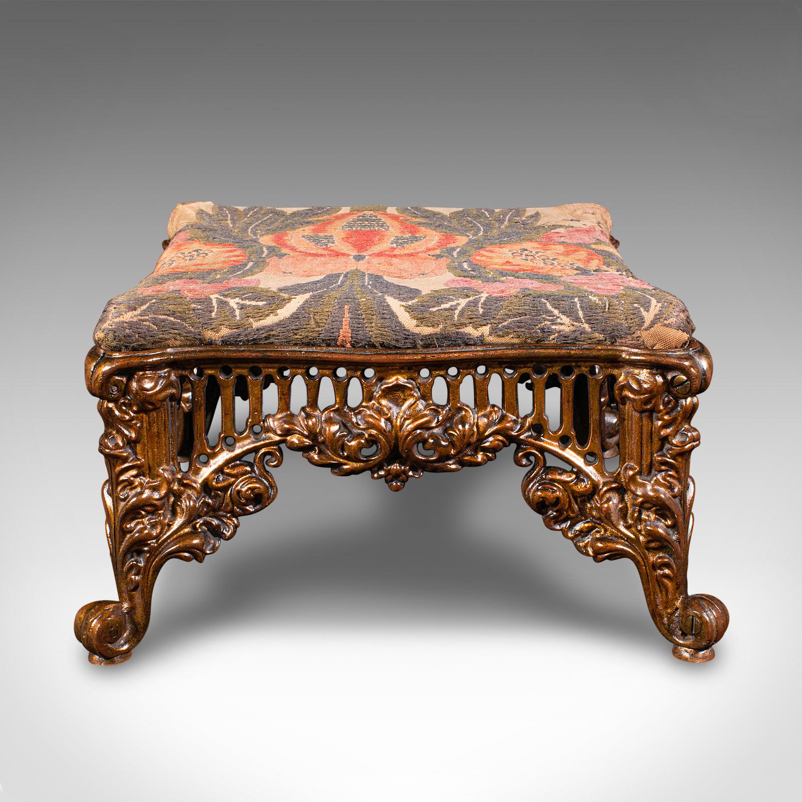 This is an antique embroidered footstool. An English, gilt brass fireside or bedroom stool, dating to the early Victorian period, circa 1850.

Fascinating example of Victorian craftsmanship from the time of the Great Exhibition
Displays a desirable