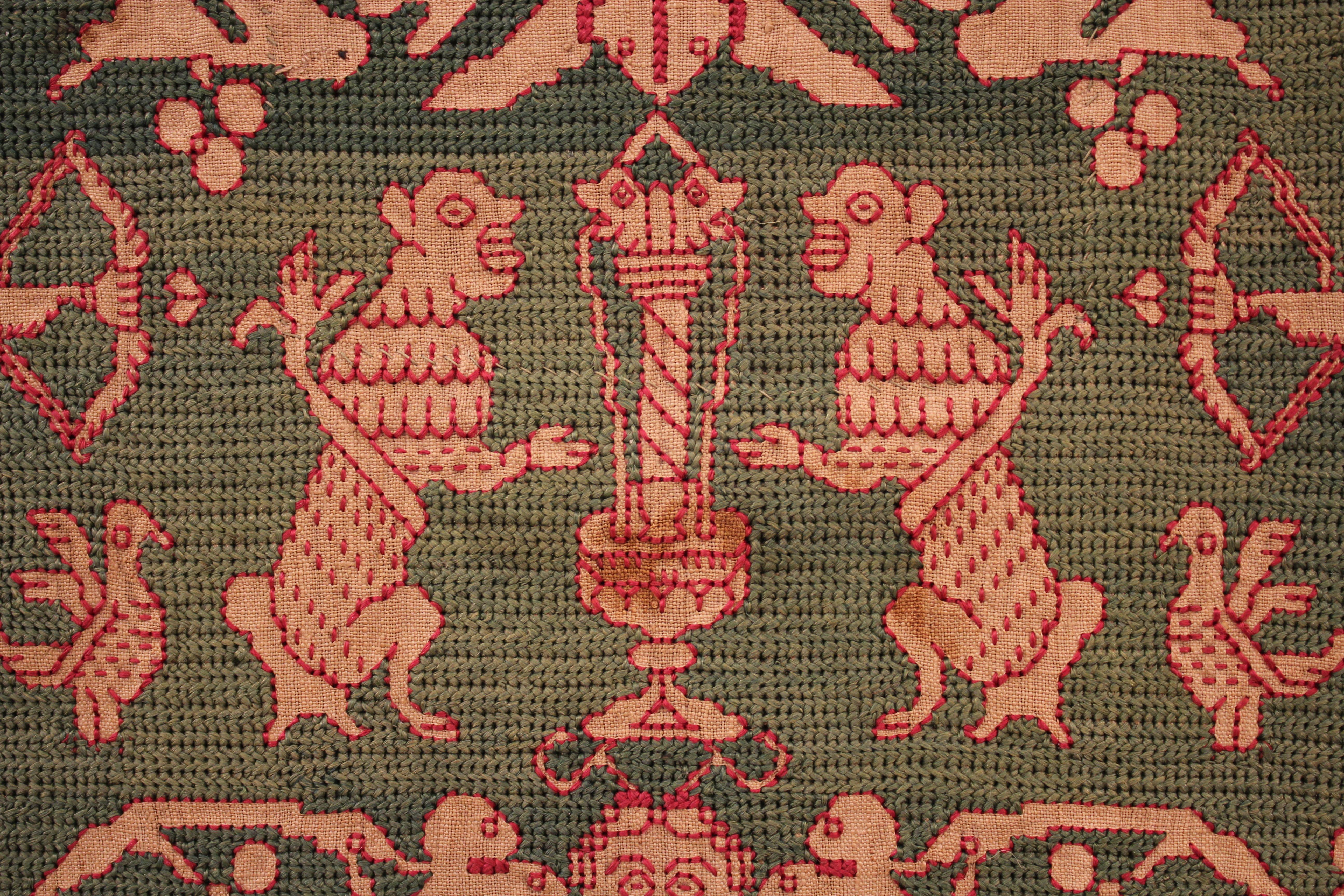 A very rare, early Italian embroidery from Sicily very finely worked in emerald green silk on a gauze or linen background. It depicts a flamboyant pattern of grotesques alternated to angels flanking a pair of fantastic animals. The two-headed eagle