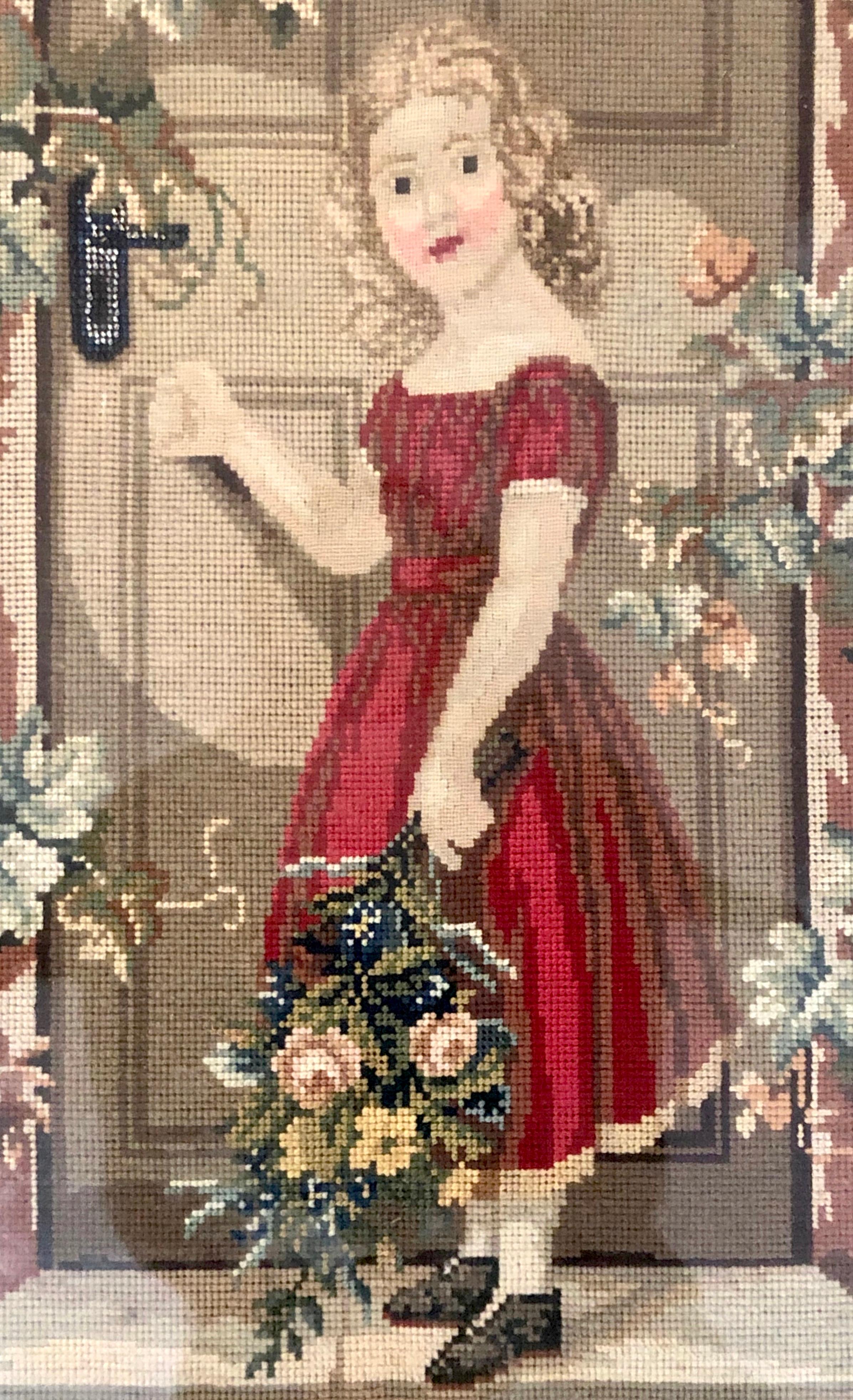 This highly amusing and unusual little wall cabinet for keys is decorated with a charming embroidery picture of a little girl wearing a red dress with a white petticoat. She is standing with a key in her right hand on the door step outside a front