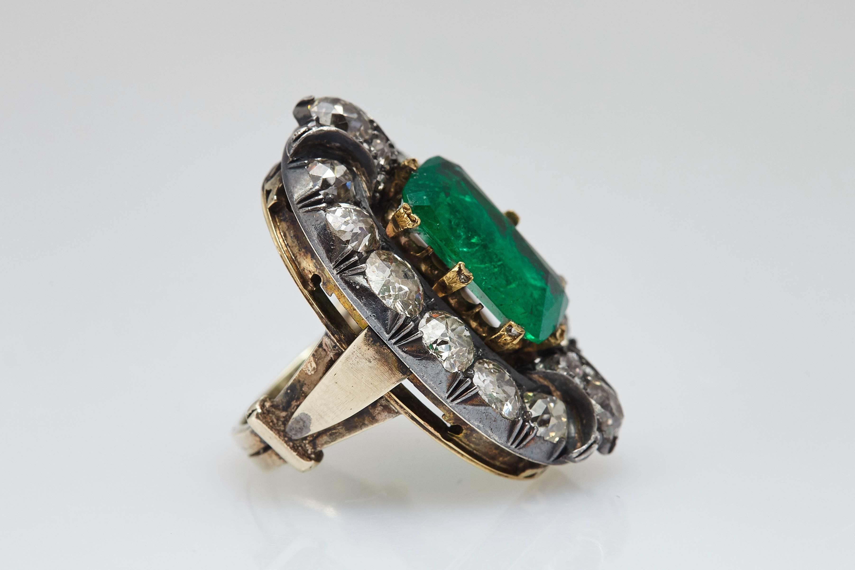 A beautiful antique diamond and Colombian emerald (4.84 carats) ring, mounted on the mixed gold and silver mounting typical of the period. Made in Italy, circa 1890.