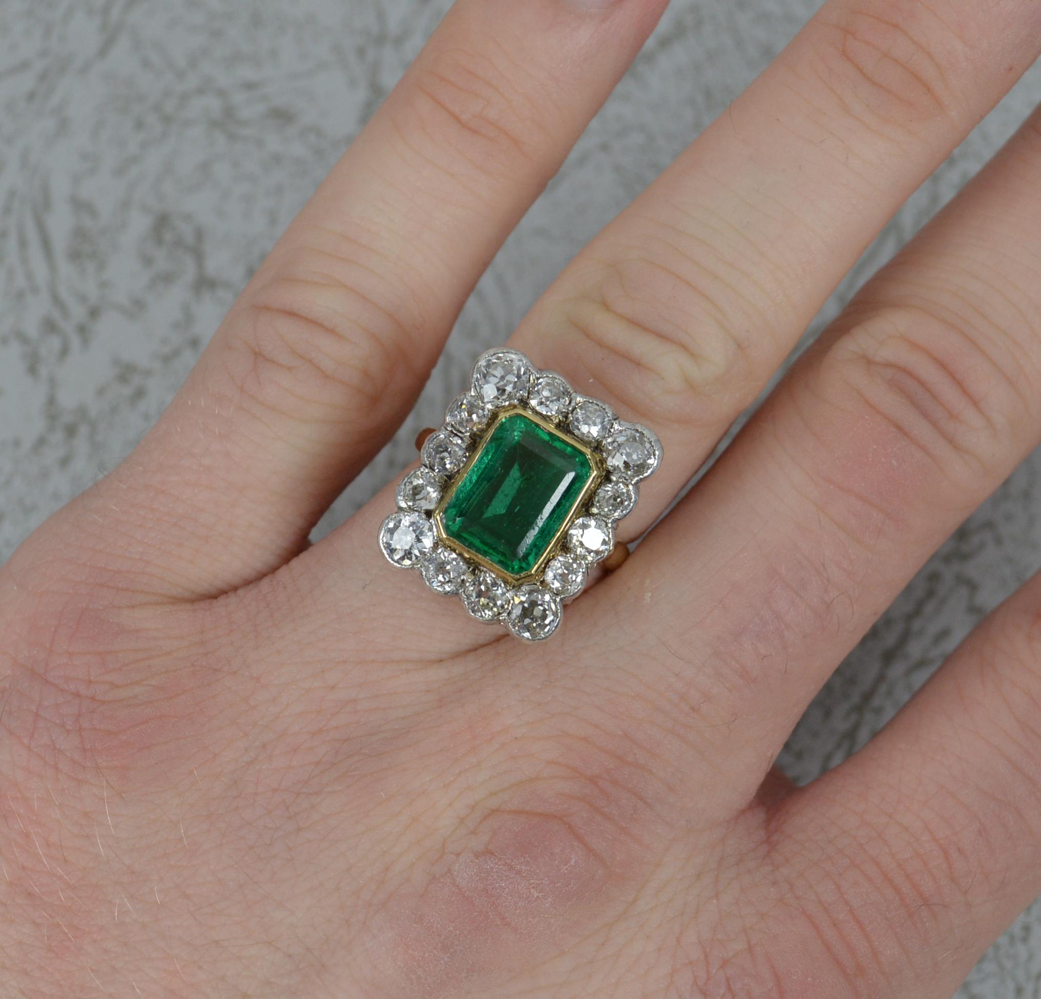 A superb Emerald and Diamond cluster ring, circa 1910.
Solid 18 carat yellow gold shank with platinum head setting.
8.3mm x 10.9mm natural emerald. Complete with certificate confirming natural emerald, minor enhancement only.
Surrounding are