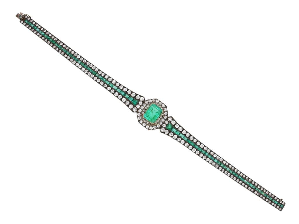 Antique emerald and diamond bracelet. Set to centre with an octagonal emerald-cut natural Colombian emerald with no colour enhancement in an open back rubover setting with a weight of 3.00 carats, encircled by a double row of round old cut diamonds