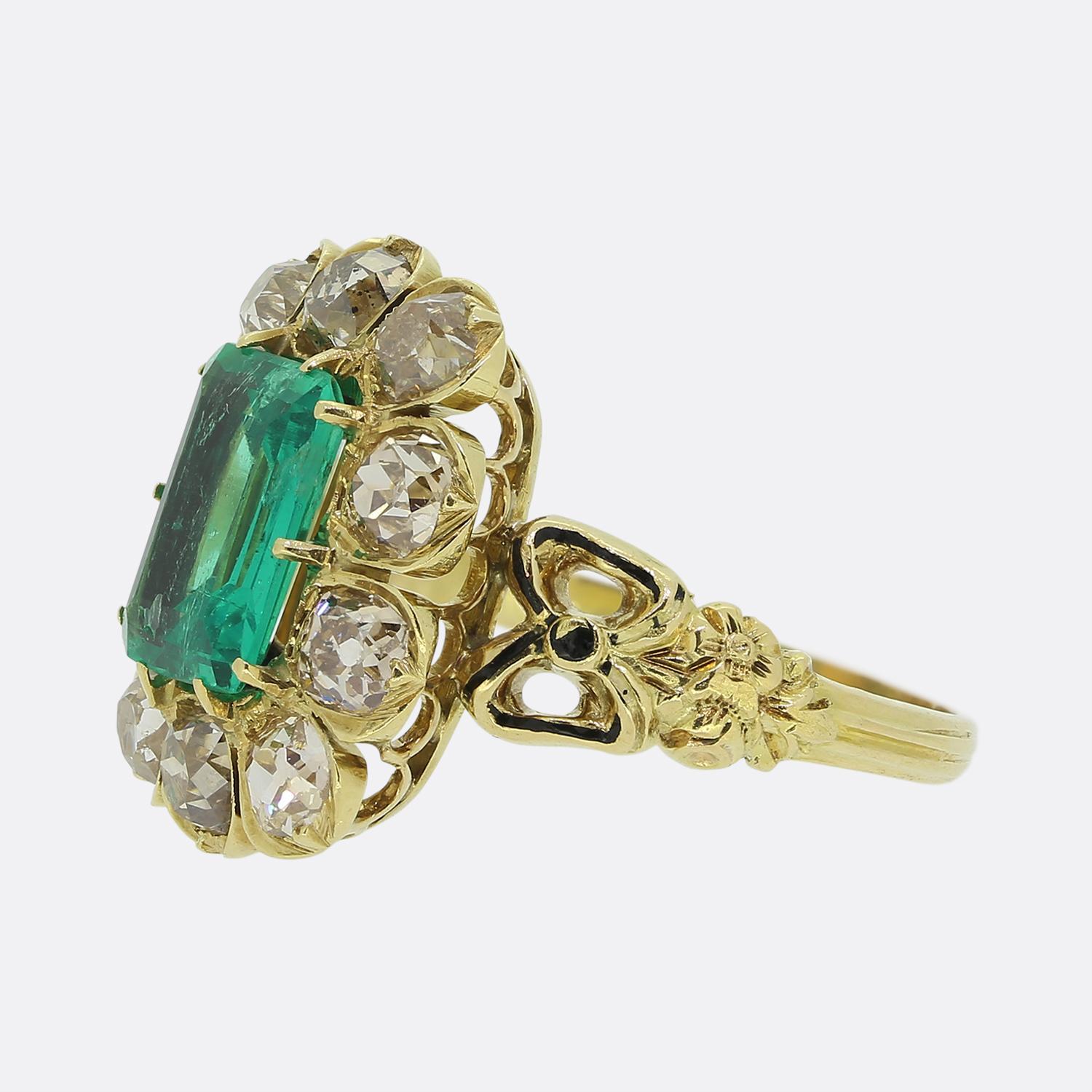 Here we have a refined antique cluster ring taken from the later stages of the 19th century. This antique piece has been crafted from a rich 18ct yellow gold and showcases a lively electric green emerald cut emerald at the centre of the face. This