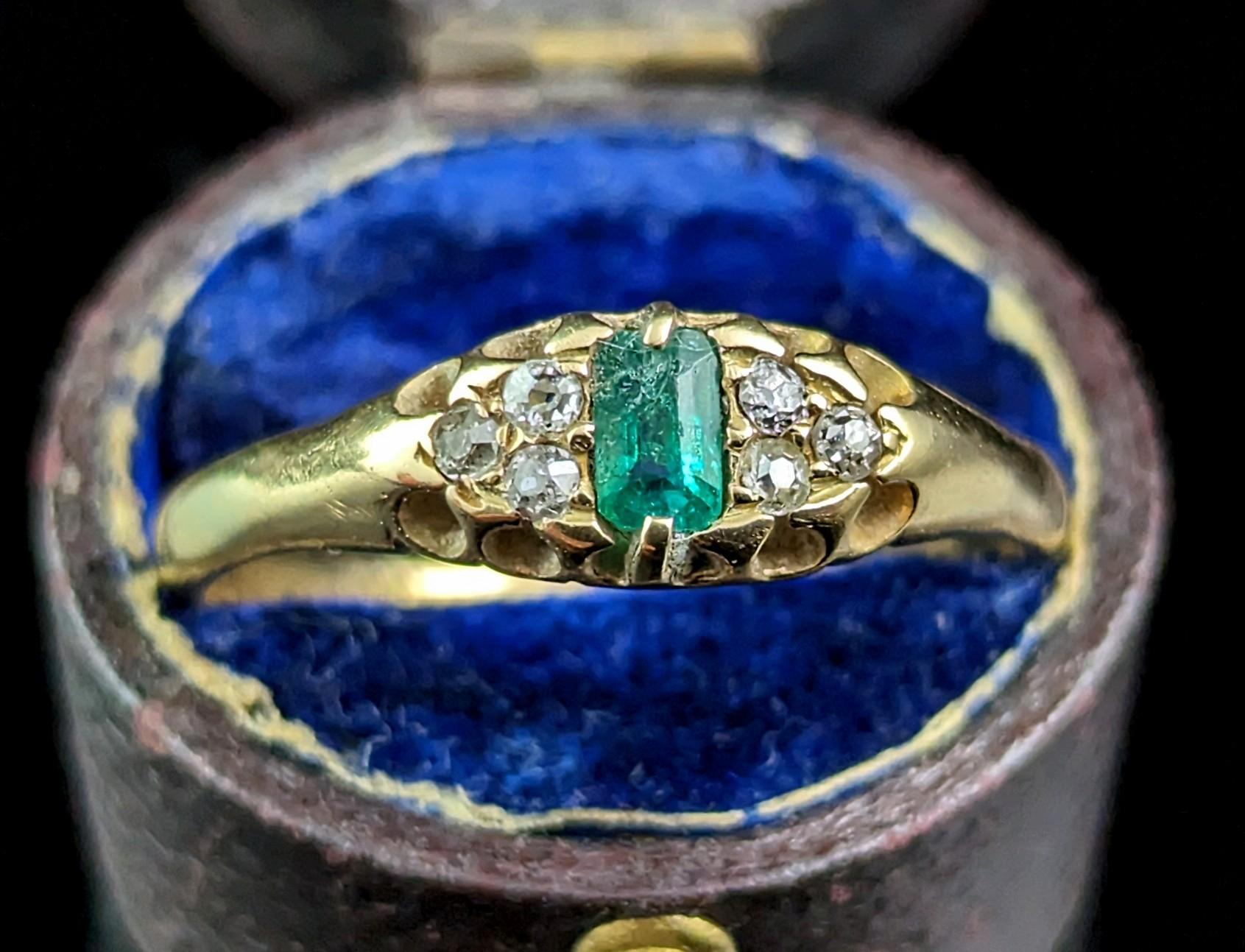 This antique Emerald and Diamond ring exudes beauty and luxury.

This impeccable ring is crafted in rich buttery 18ct gold with a smooth polished band and a boat head style setting.

The centre features a gorgeous emerald cut, lush and opulent green