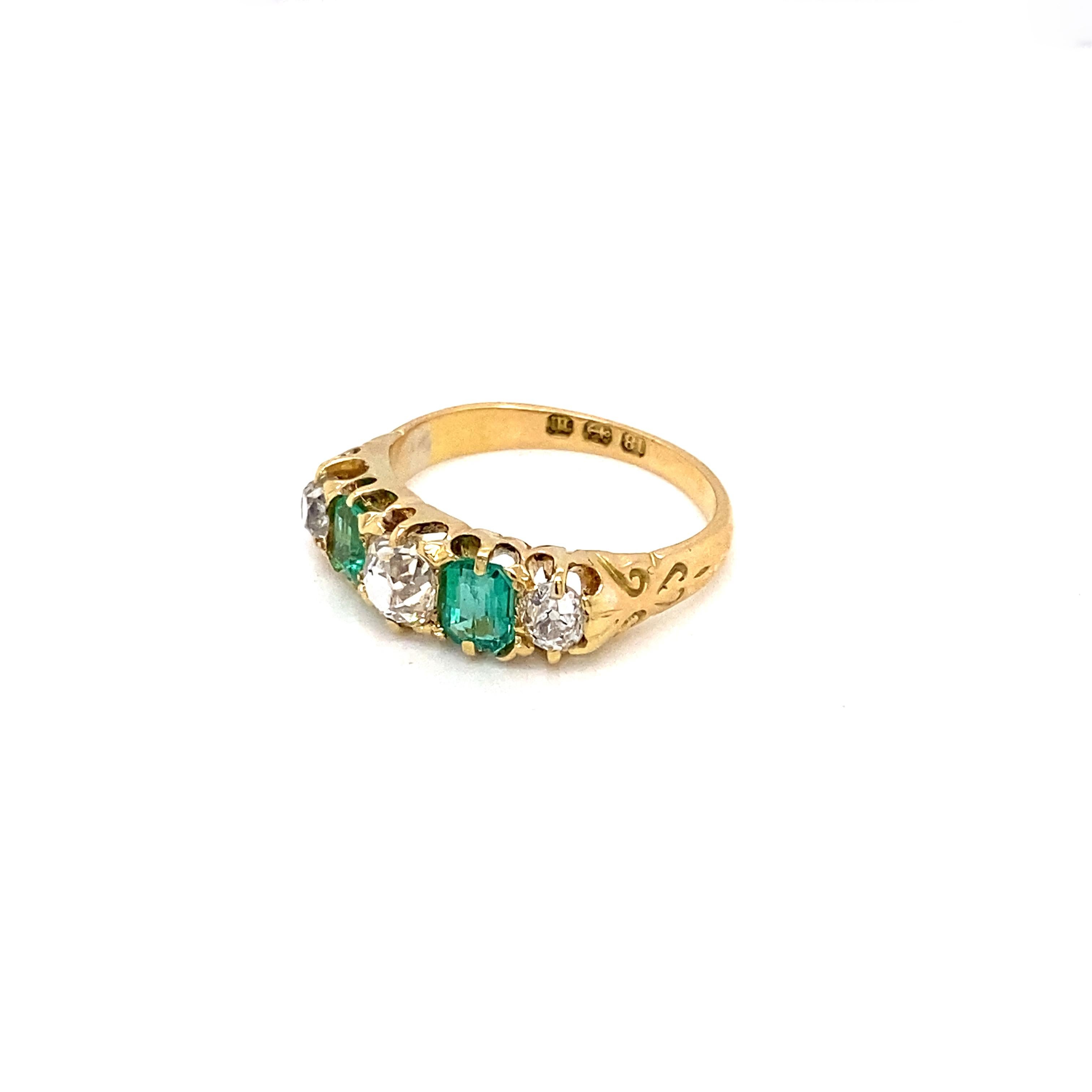 Introducing a truly exceptional antique five-stone ring, dating to 1896, that showcases the enduring beauty of emeralds and diamonds, set in warm 18 carat yellow gold. 

The ring features 3 old mine cut diamonds, with an approximate combined weight
