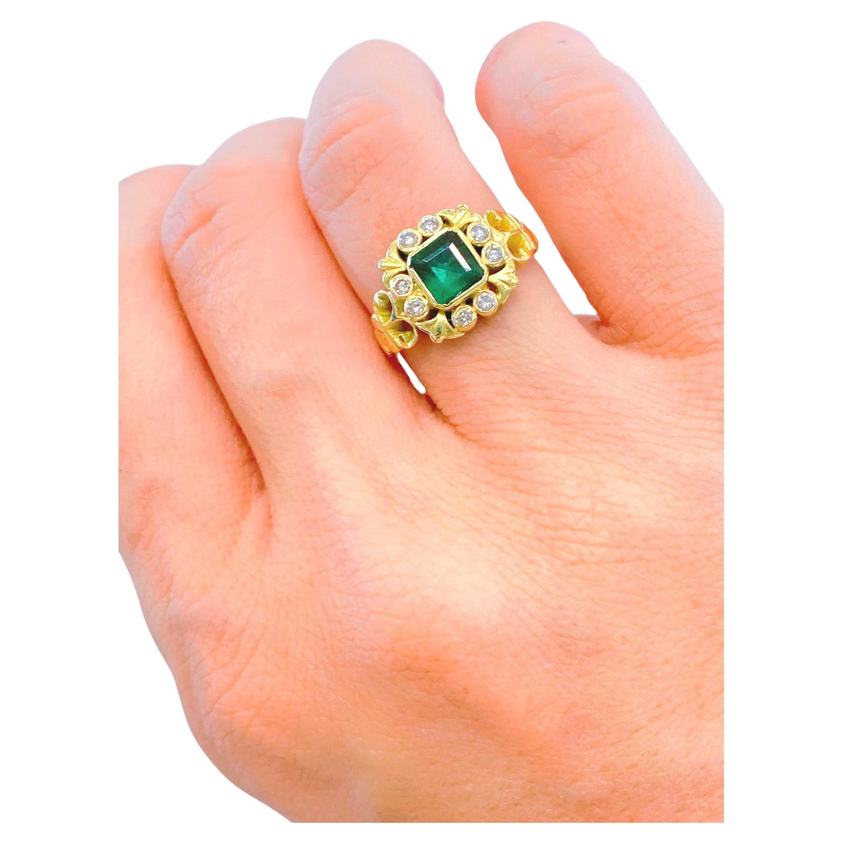 Antique 18k gold ring centered with a natural green emerald diameter of 5.80mm×5.60mm flanked with old mine cut diamonds estimate weight 0.40 ct hall marked 750 gold finest