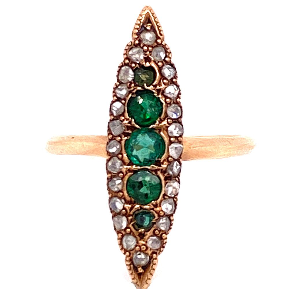 Georgian emerald and diamond navette ring. The navette ring is a very old and quintessentially vintage design. This ring features 5 emerald gemstones in the center surrounded by 24 rose cut diamonds. The ring measures 25mm in width and is currently