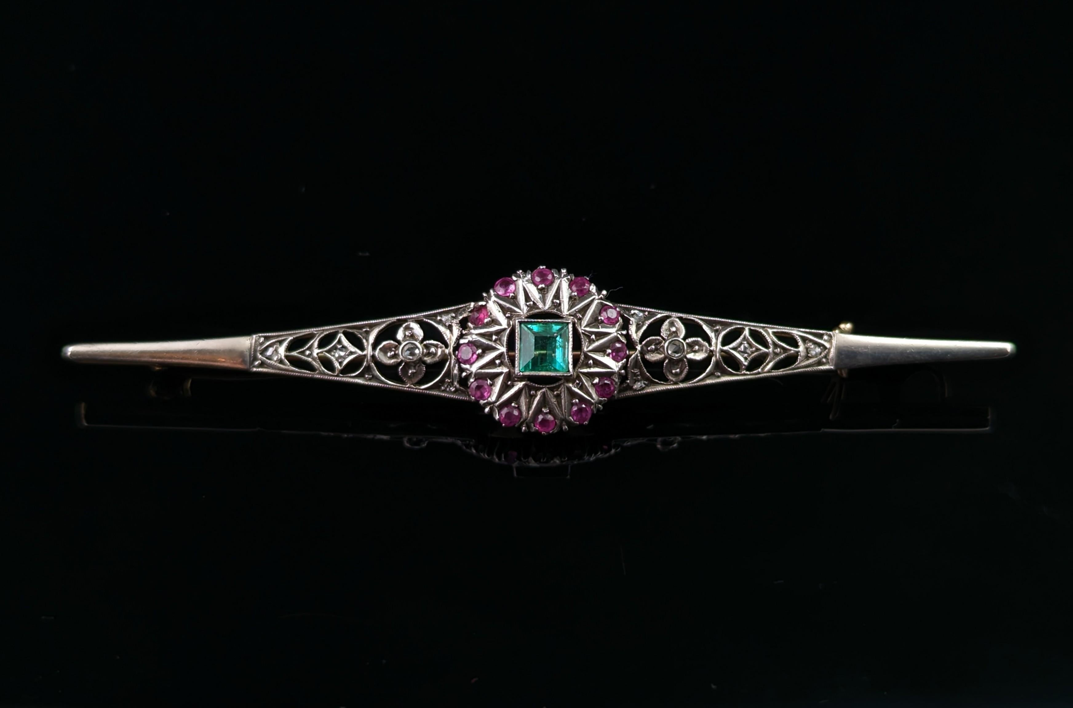 This magnificent antique Art Nouveau Emerald, Diamond and Ruby brooch is just breathtaking!

A beautifully designed piece with the greatest attention to detail, well crafted in the Art Nouveau manner with openwork and scrolling features, it is a bar