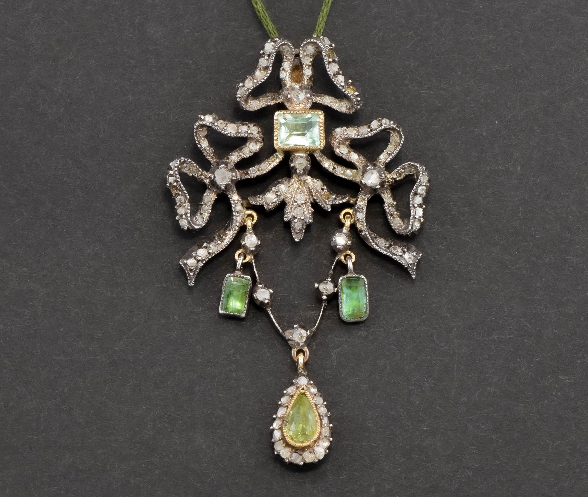 Very elegant - yet eye catching - this wonderful antique pendant has French hallmarks.

Crafted of gold testing between 14K and 18K, along with silver, the pendant features rustic rose cut diamonds and old glowing foil backed beryl/emeralds. Three