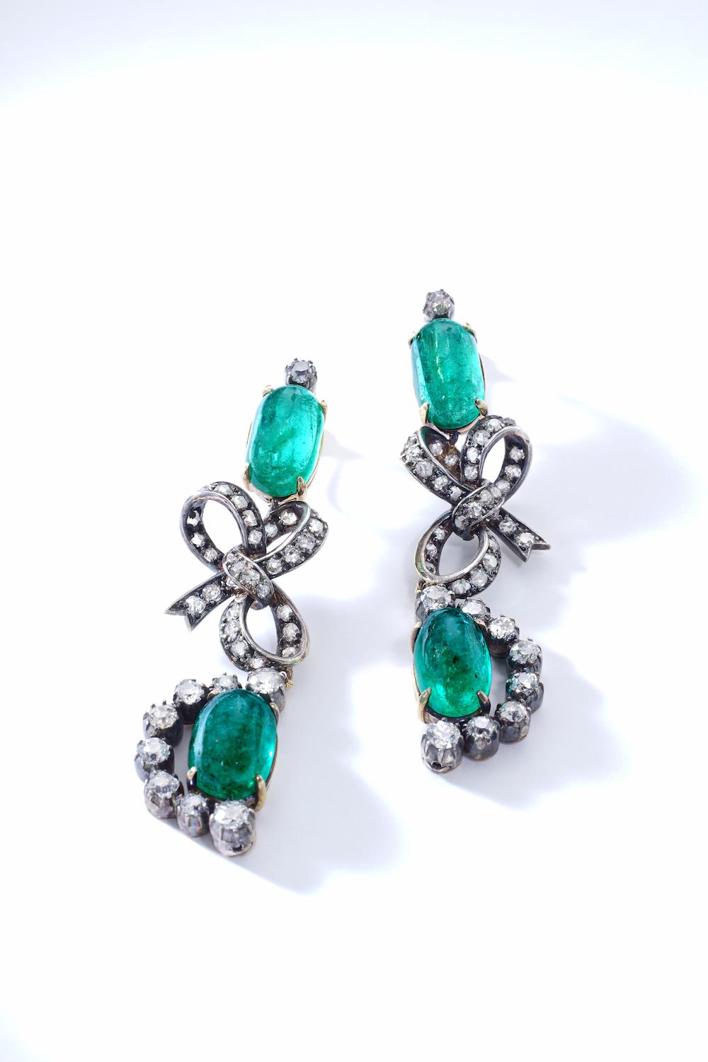So Lovely! Those Ear Pendants looks like a gift, like candies!
Each Earrings is highlighted by delicate a bow.
Cabochon Emerald surrounded by Old-mine cut diamond on silver and gold. 
Late XIXth Century.
Total Length: 2.56 inches (6.60