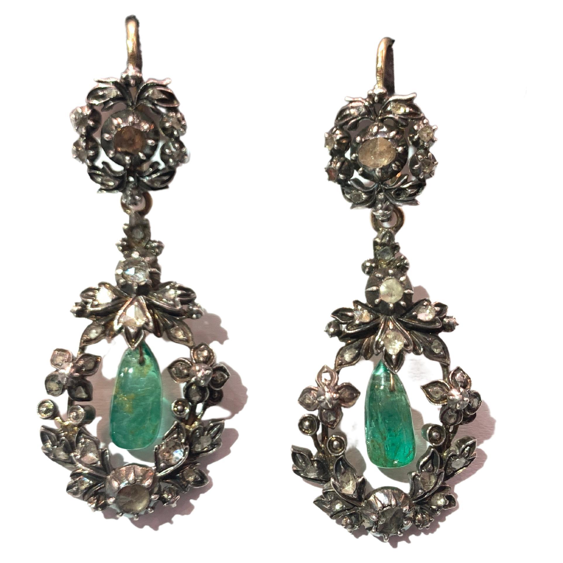 Antique Emerald & Diamond Day & Night Earrings

A pair of 18 karat gold and silver earrings with floral motifs set with 2 cabochon emeralds framed by rose cut  diamonds. Detachable bottoms

Day Length: 0.88