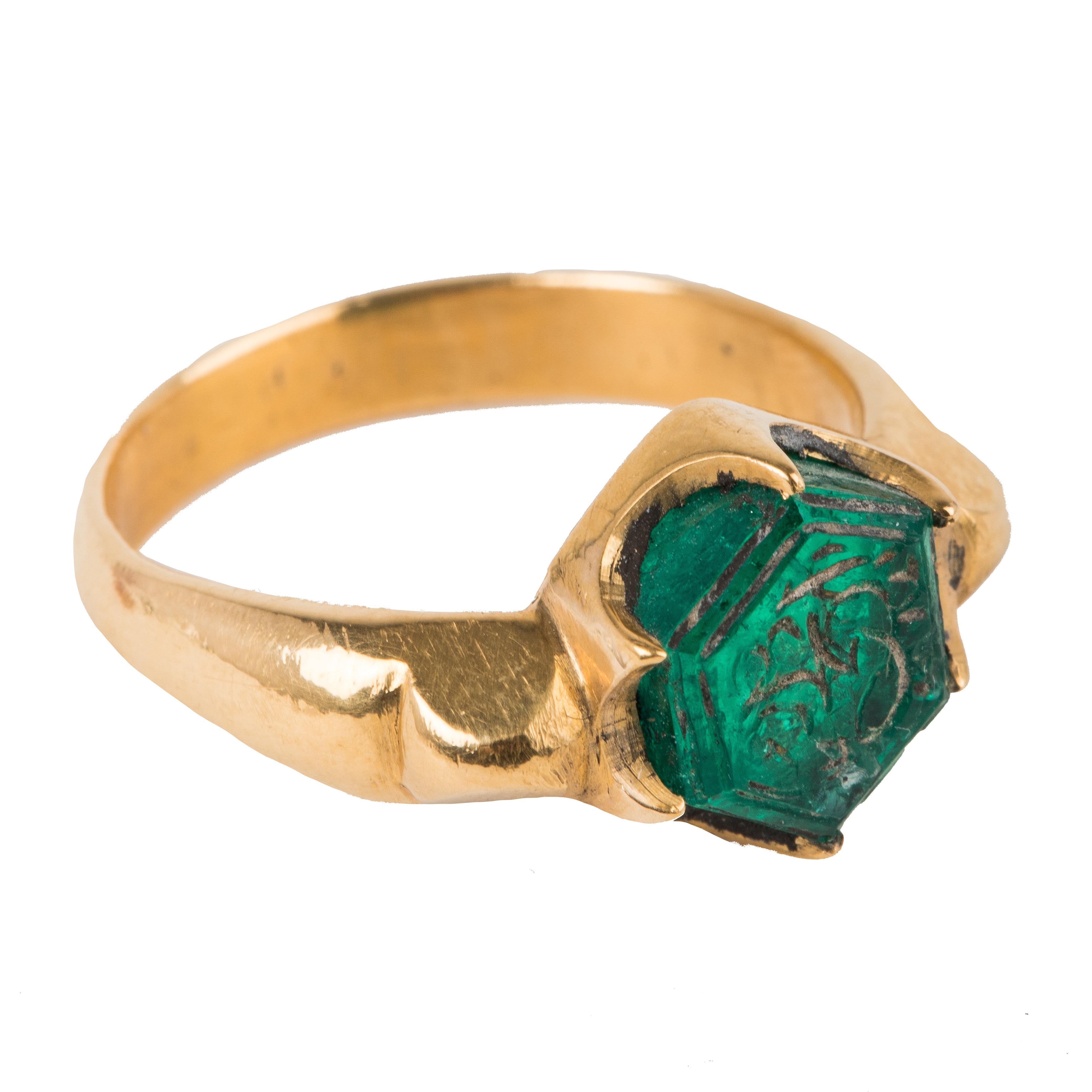 This emerald is appx 3.5 carats and originates from Colombia and has been set in 22K gold.
The emerald has Persian verses inscribed on the emerald. The emerald has been cut into a Hexagon and is an old Mughal style ring that has been made in India