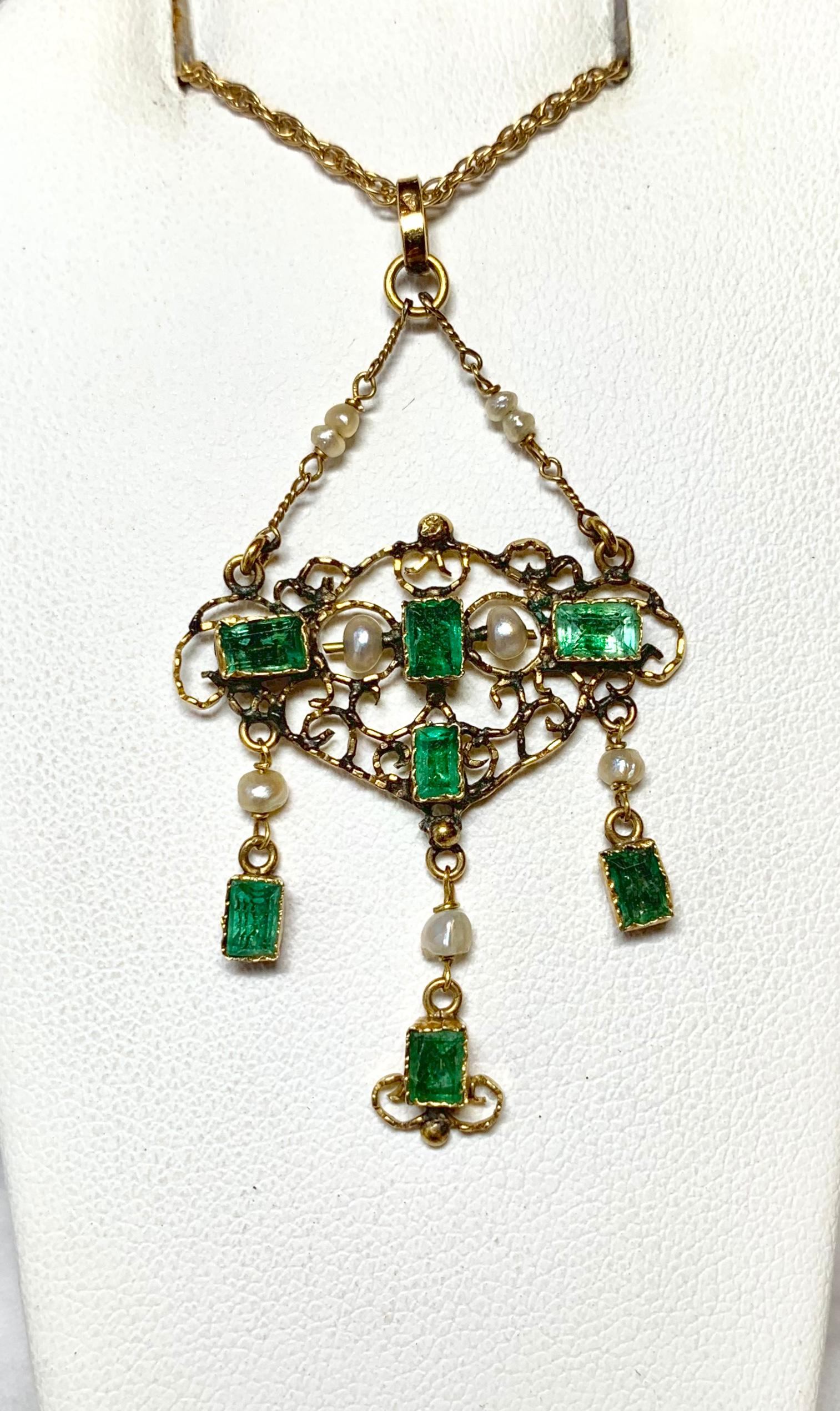 This is an antique Emerald and Pearl Pendant Necklace set with seven gorgeous green emerald cut rectangular Emeralds in the Renaissance Revival Style.  The Emeralds total approximately 1.4 Carats and they are accented by silvery white pearls and set