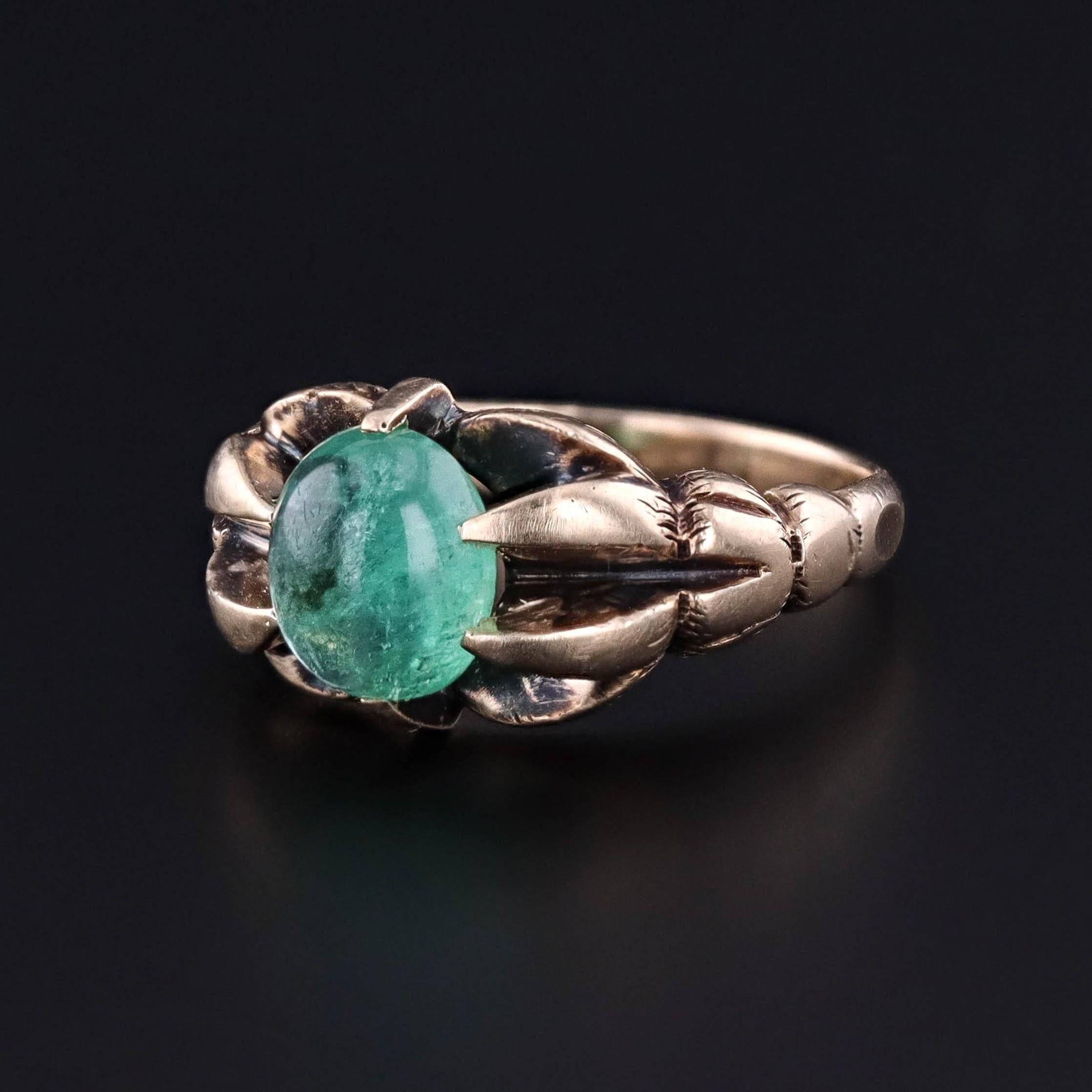 Antique Emerald Ring: This antique ring (circa 1910-1920) features a 1.56ct natural emerald cabochon mounted in 10k gold.

The face of the ring measures 0.45 inches from north to south.  It weighs 6.73 grams and is in great condition. 

The ring is