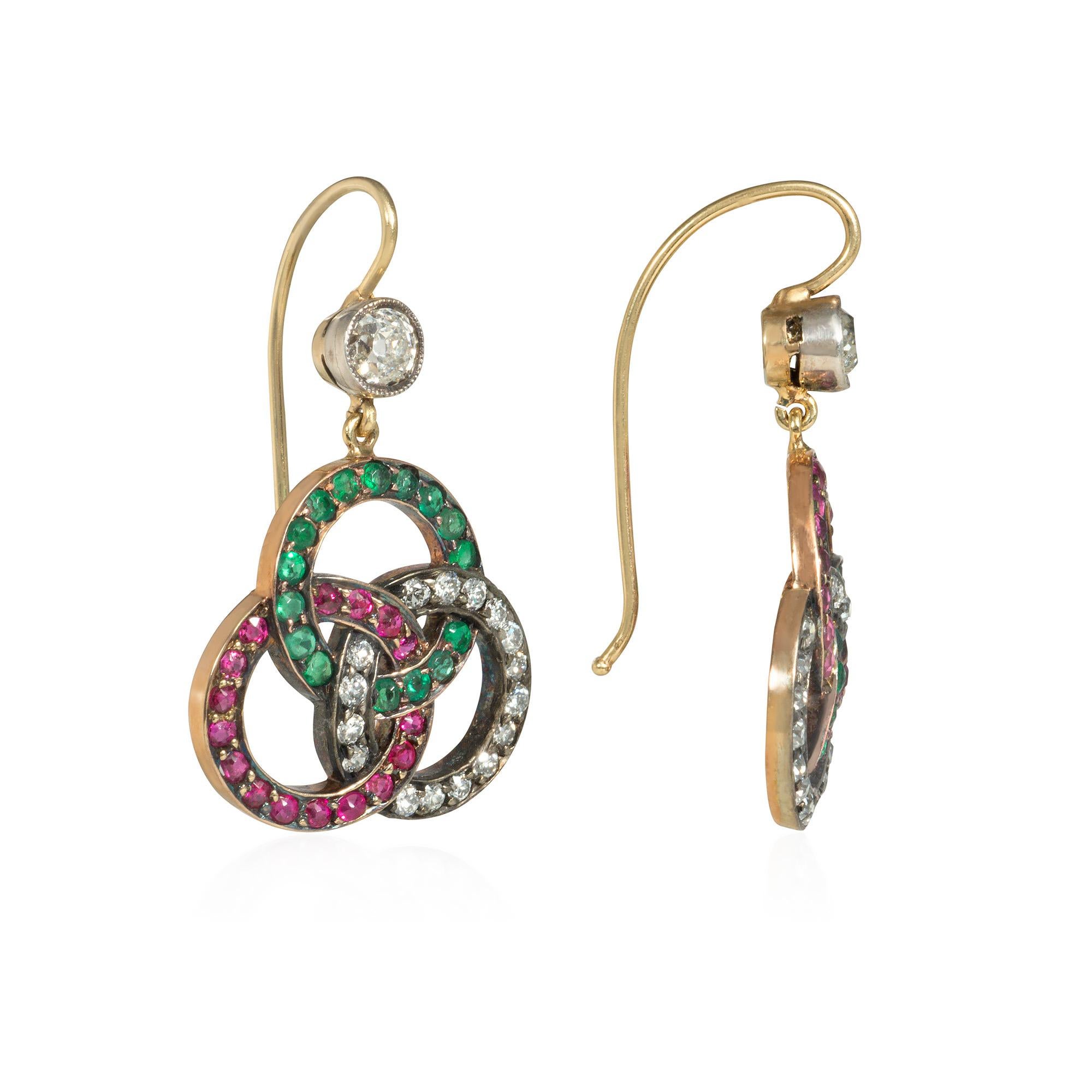 A pair of antique Victorian period multi-gemstone earrings comprising ruby, emerald, and diamond pendants of open trefoil design, suspended from diamond surmounts, in 14k gold.

* Please do not hesitate to contact Kentshire for photos of specific