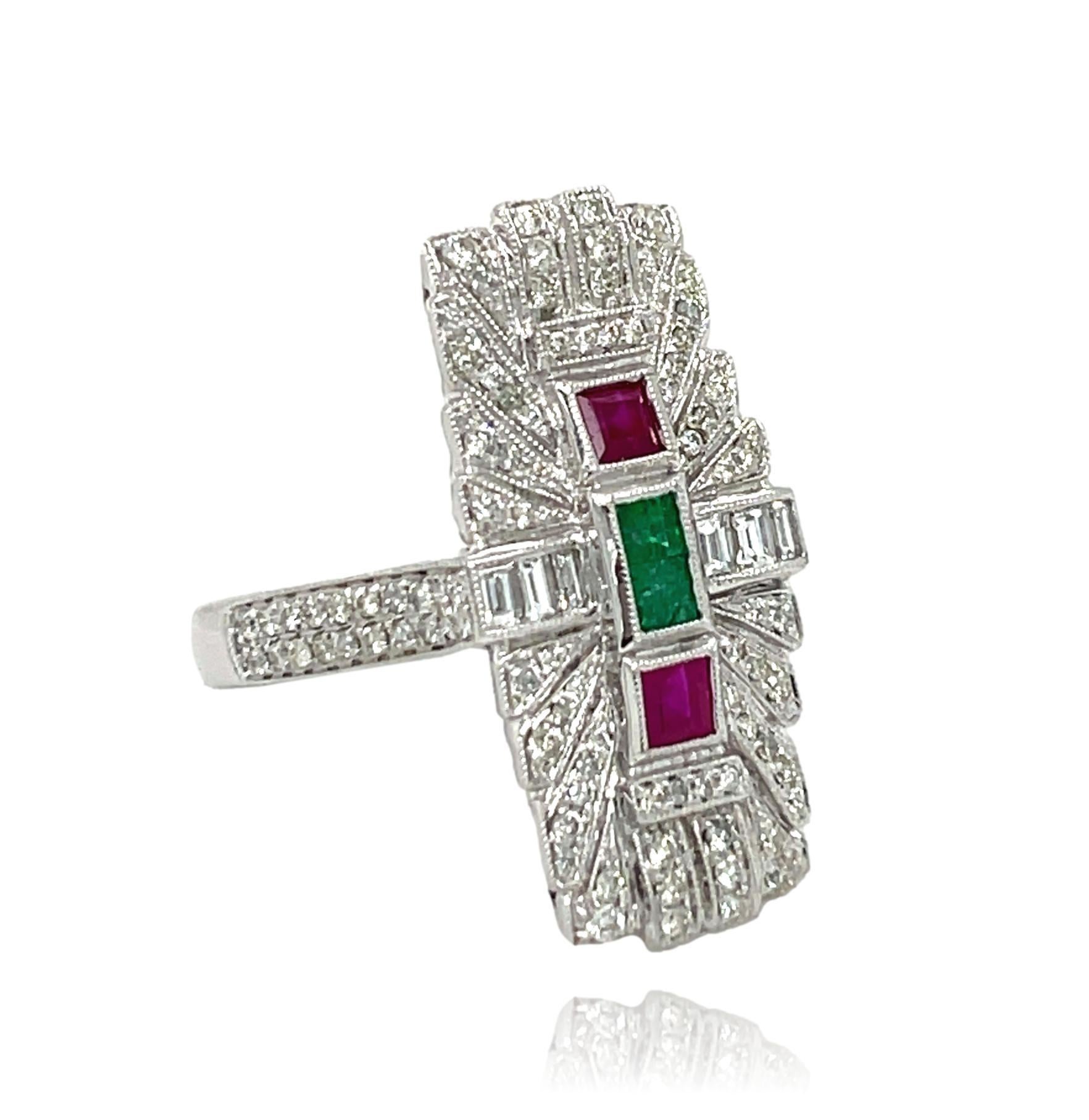 This stunning Antique ring has natural square shaped Emeralds and Rubies, and round and baguette Diamonds set in 14 karat white gold. There are sparkling brilliant cut round diamonds on the shank for a delicate accent. This ring will be shipped in a