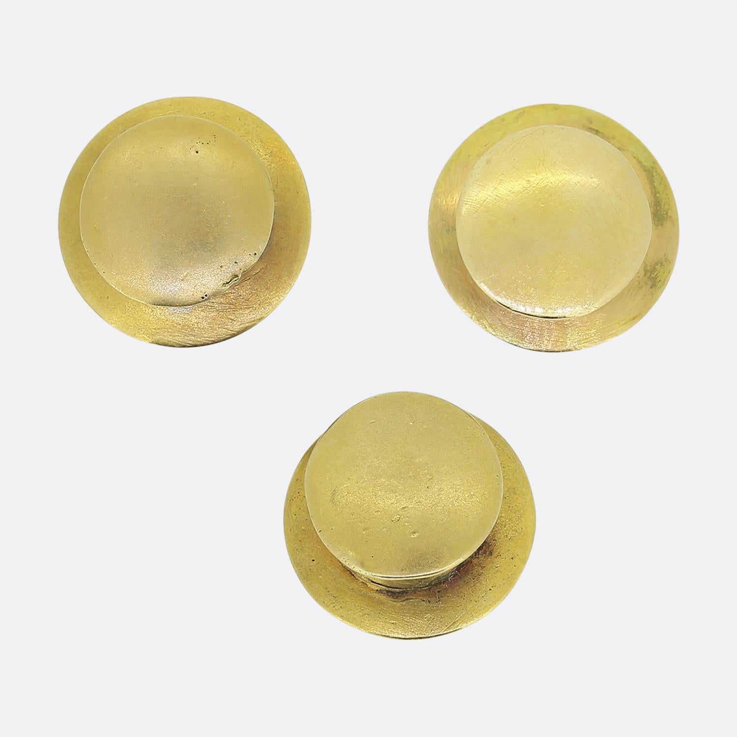 Here we have an excellent antique shirt stud set. A trio of shirt studs have been crafted from a rich 18ct yellow gold into a circular shape with a convex centre. Each piece plays host to a single oval faceted vivid green emerald in a fine milgrain