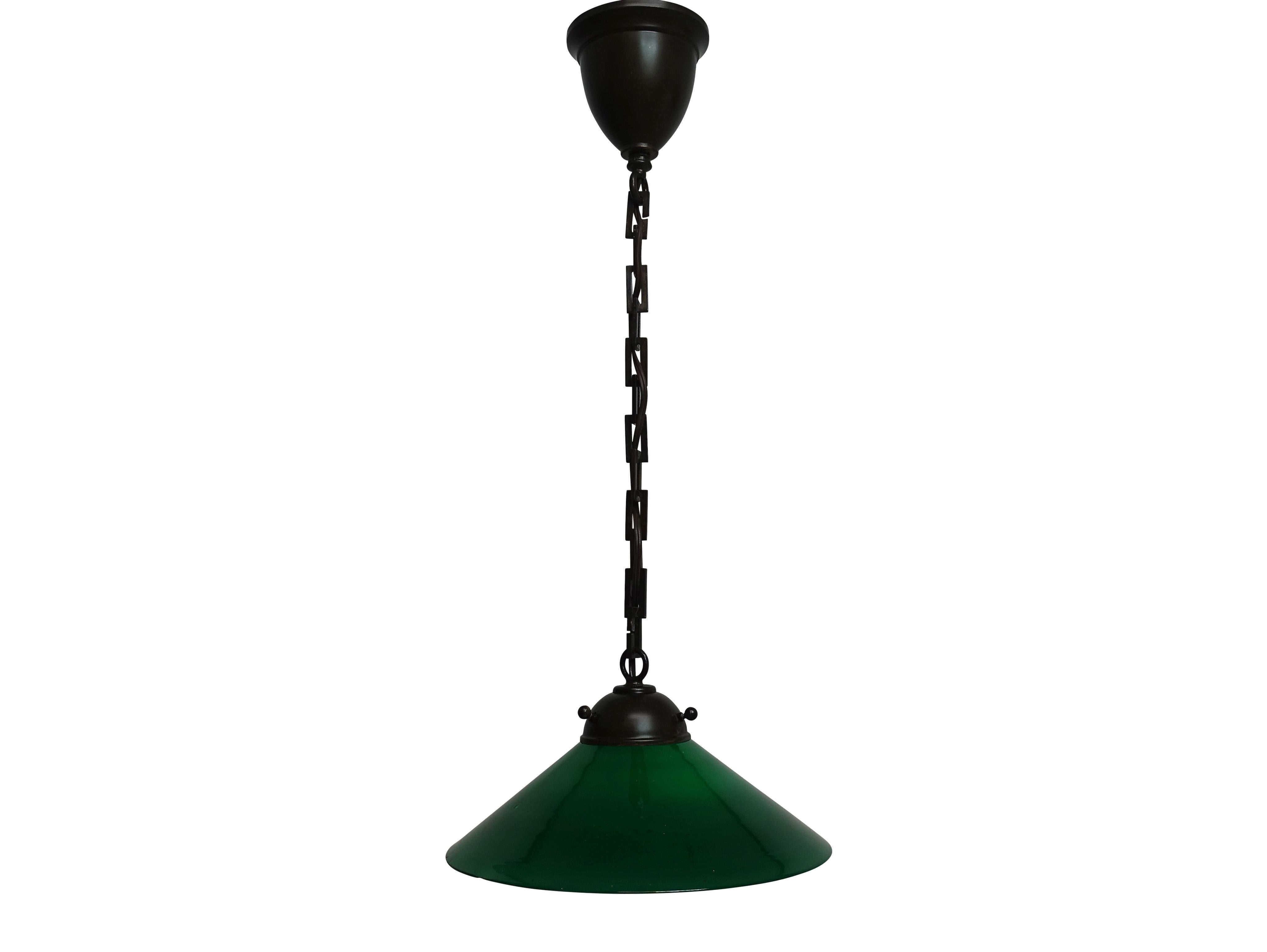 An antique small emerald green encased glass light shade made into a hanging pendant light fixture. Newly wired, holds a single standard size light bulb. Chain can be shortened or lengthened to desired height.