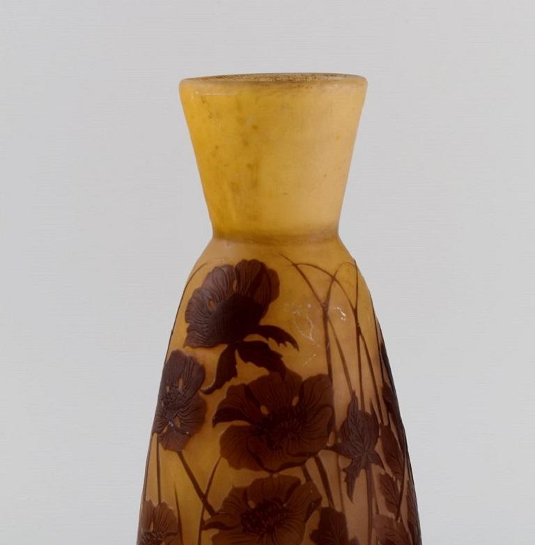 Antique Emile Gallé vase in dark yellow and light brown art glass carved in the form of flowers and foliage. 
Early 20th century.
Measures: 25.5 x 11.5 cm.
In excellent condition.
Signed.