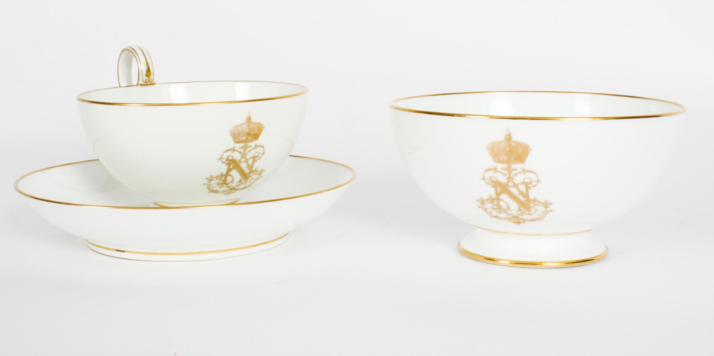 This is an important fine Sèvres porcelain breafast cup and saucer with a footed sugar bowl dating from the mid 19th Century.
 
The cup saucer & bowl all feature the gilt crowned N cipher with gilt line borders on a white ground and the undersides