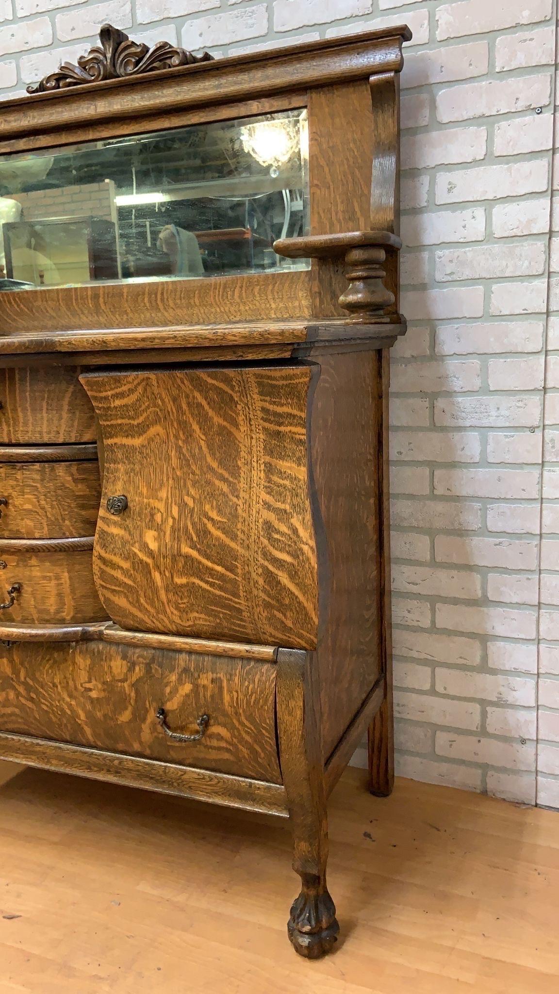 Antico buffet / credenza / mobile da bar in Oak Oak con specchio

Questa credenza antica con piano a specchio presenta una caratteristica venatura del legno di rovere tigrato. Dispone di tre piccoli cassetti centrali, di un grande cassetto alla base