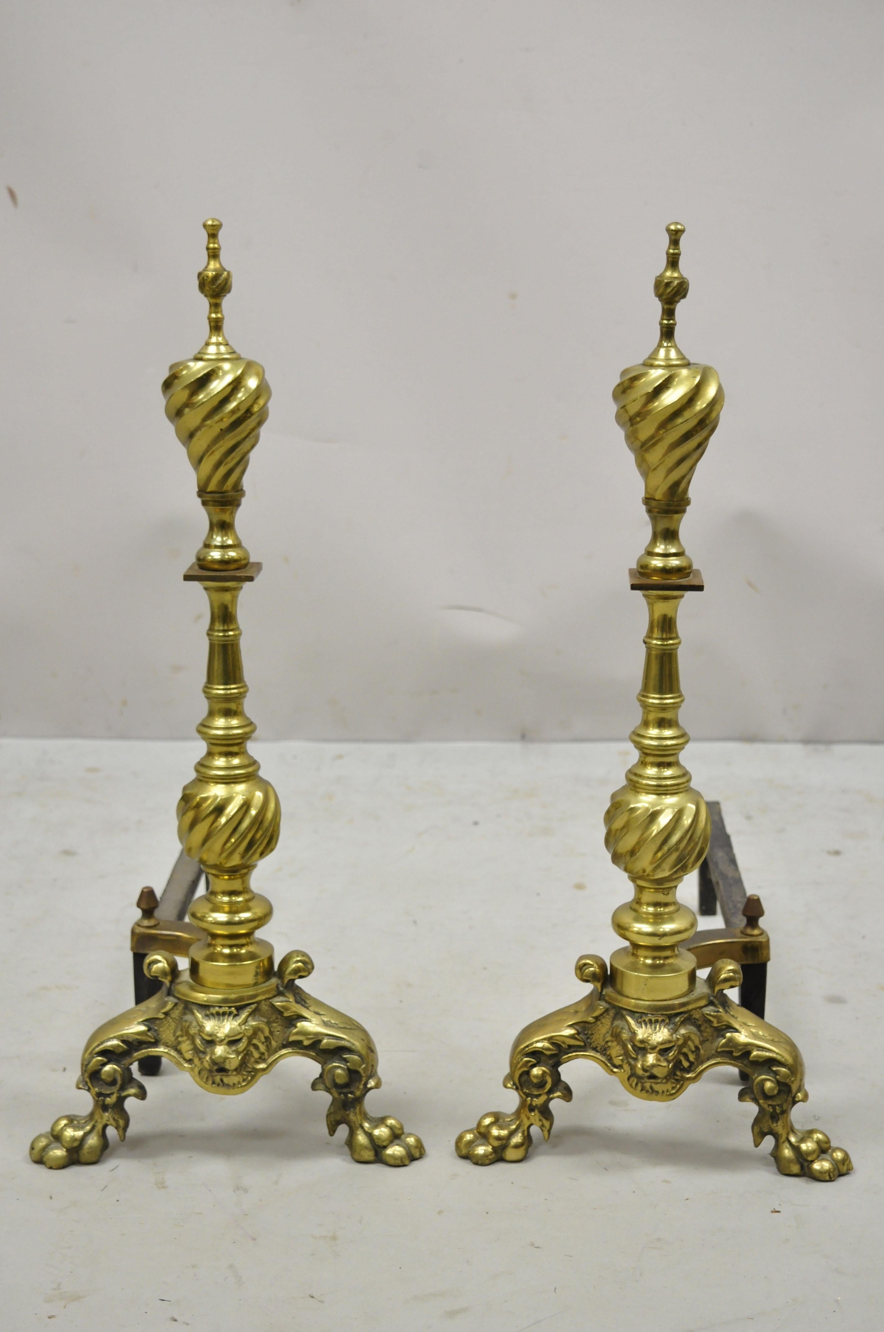 Antique French empire style brass cast iron lion head spiral twist paw feet andirons - a pair. Item features brass spiral turned column and finials, cast iron supports, lions heads to base, paw feet, very nice antique pair, great style and form.