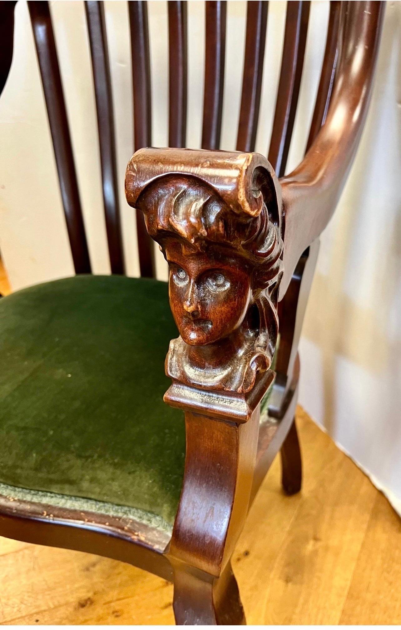 Rare, American Empire carved mahogany chair with velvet seat fabric. A real showstopper with coveted figural carved heads at front of each armrests and hoof feet. It sits well which is rare for an antique chair of this pedigree. Why not own the