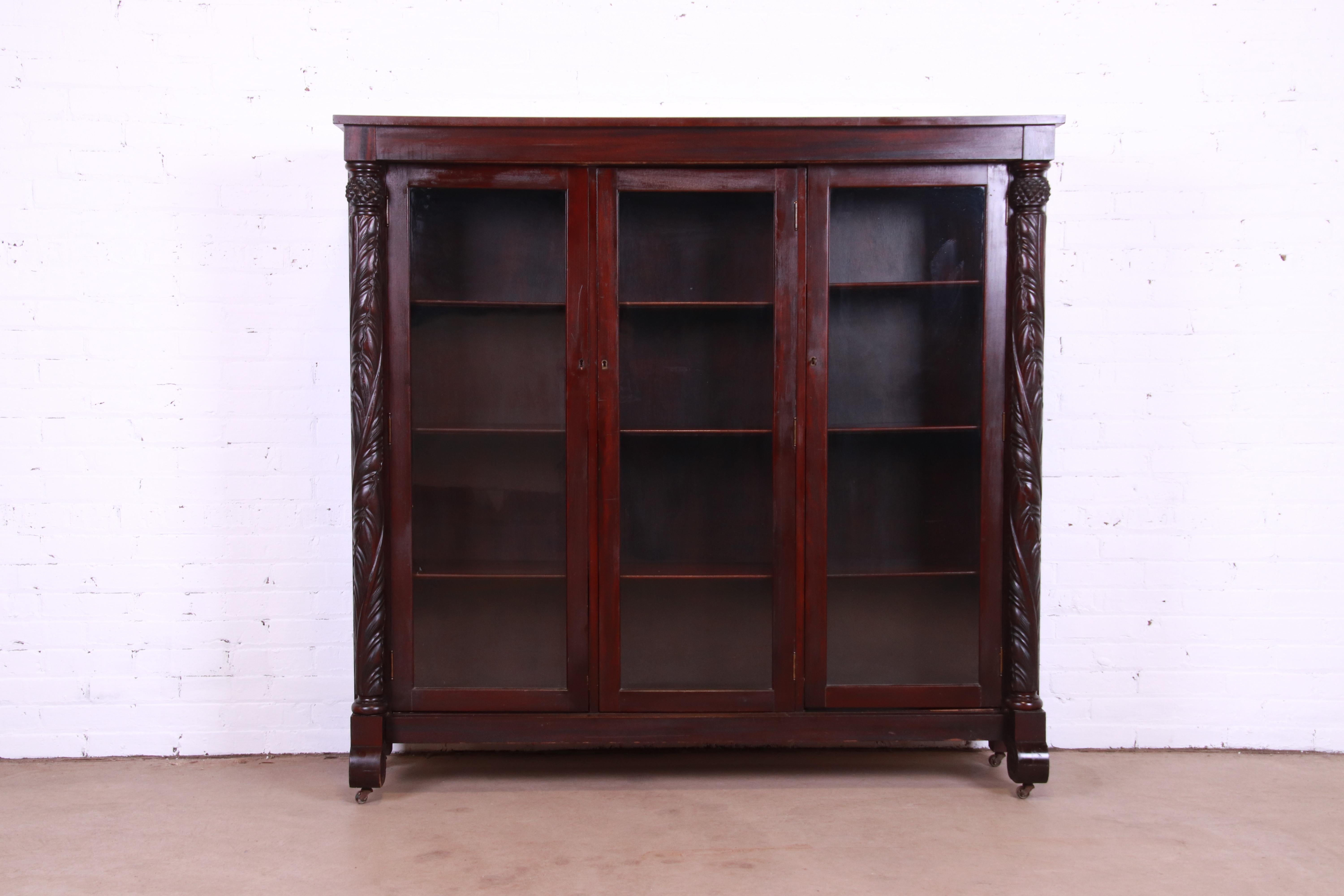 American Antique Empire Carved Mahogany Glass Front Triple Bookcase, circa 1900