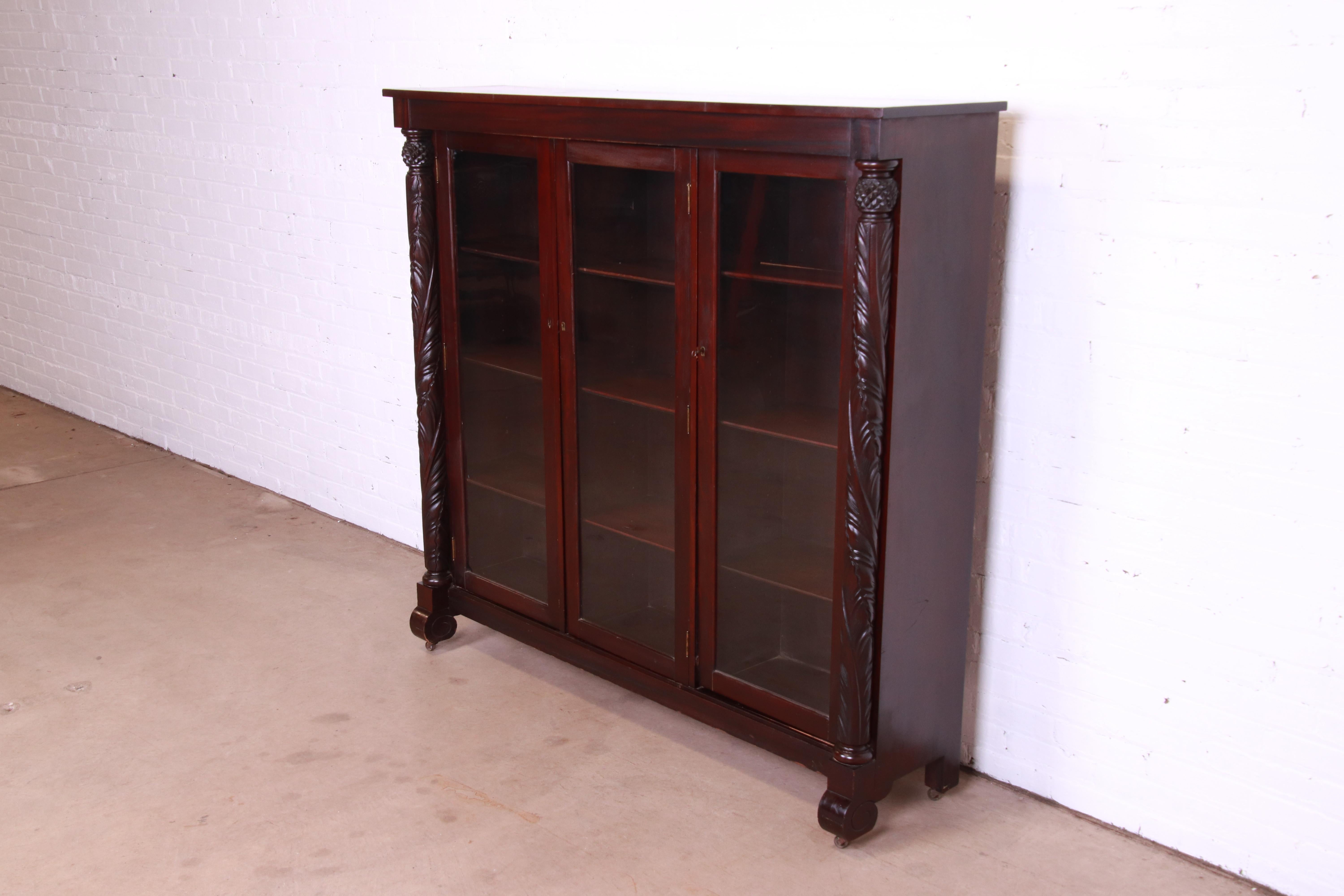 Antique Empire Carved Mahogany Glass Front Triple Bookcase, circa 1900 In Good Condition In South Bend, IN