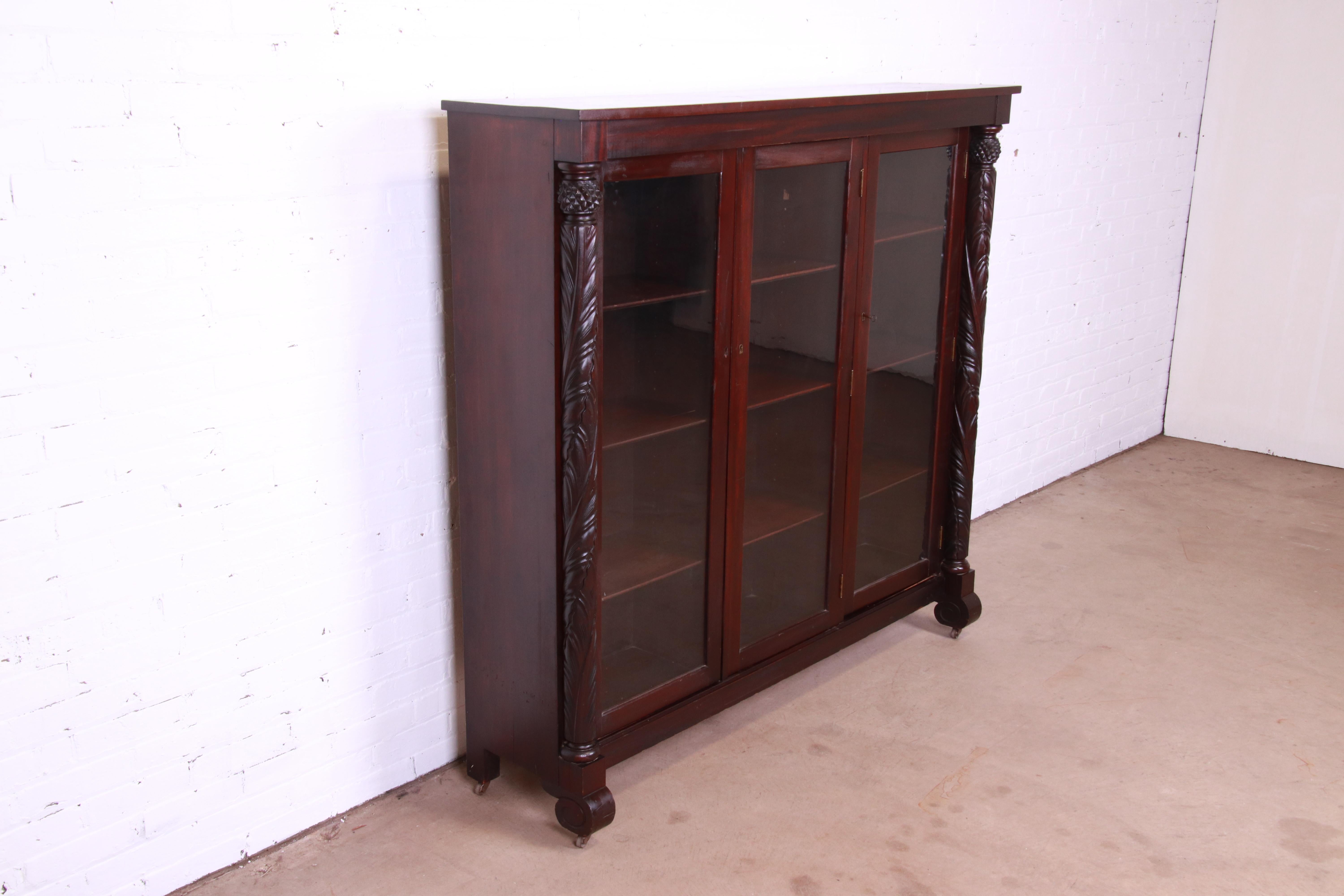 20th Century Antique Empire Carved Mahogany Glass Front Triple Bookcase, circa 1900
