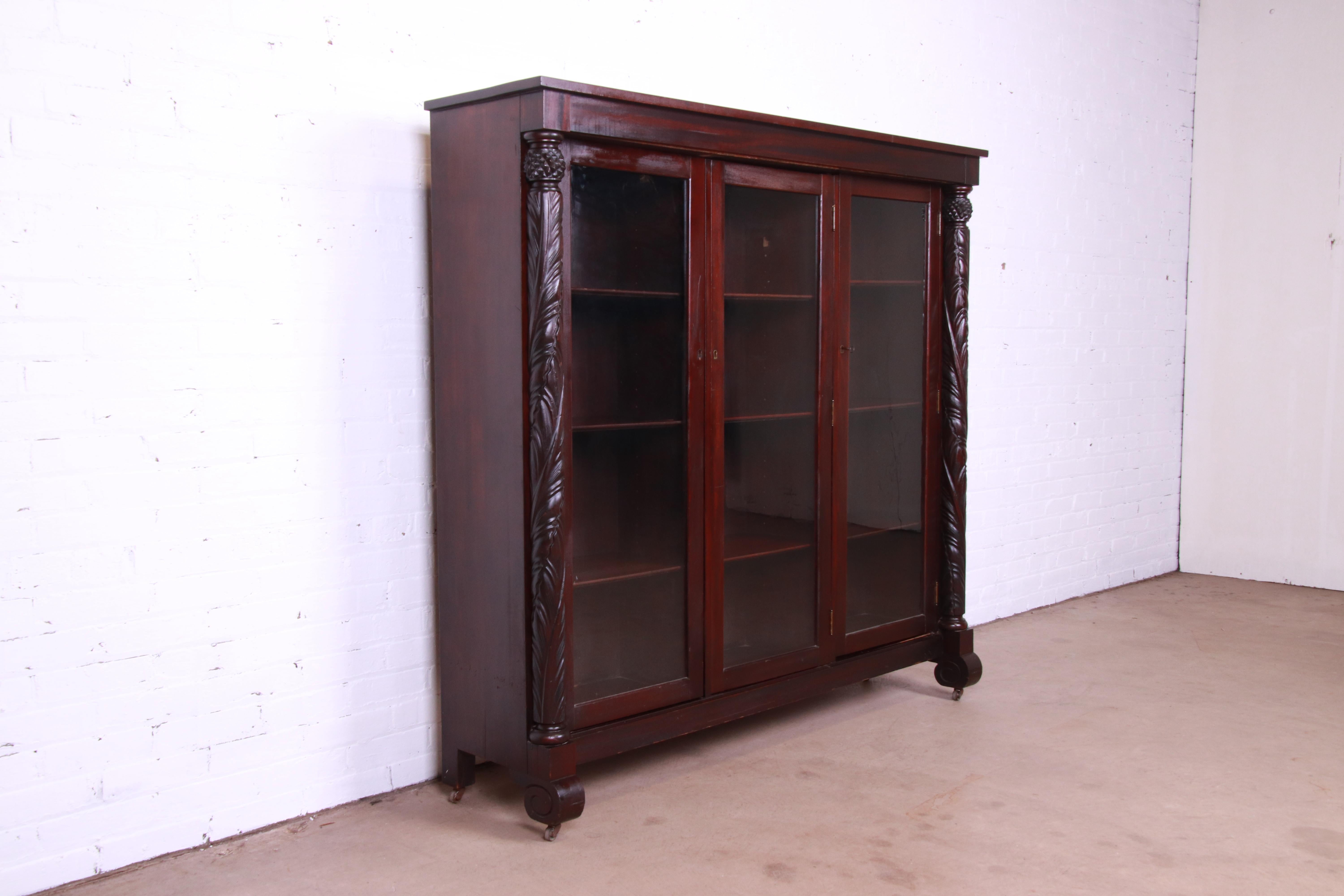 Antique Empire Carved Mahogany Glass Front Triple Bookcase, circa 1900 1