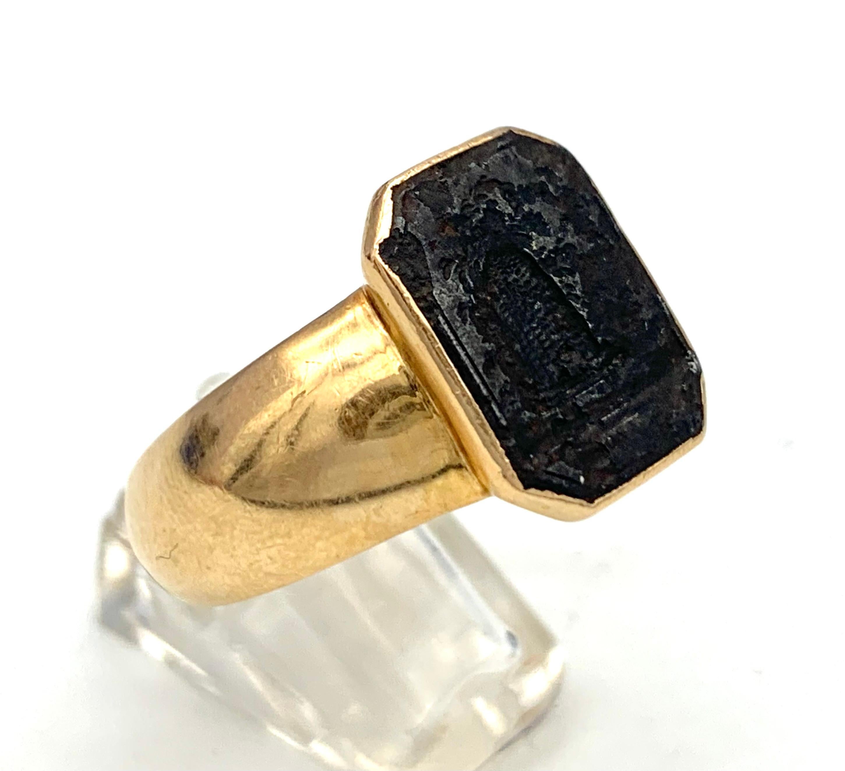 This unusual gentleman's gold signet ring has been much in use, the octagonal cast iron intaglio shows a beehive, however rust has destroyed part of the image. The gold ring is in fine condition, it is hallmarked on the outside of  the ring band. 