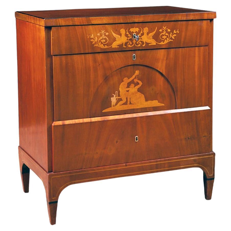 A very fine Empire commode in a light-colored Cuban/ West Indies mahogany with satinwood inlays featuring an upper drawer with small inlaid lidded compartments with original turned knobs. Line inlays continue throughout the plinth, with the top