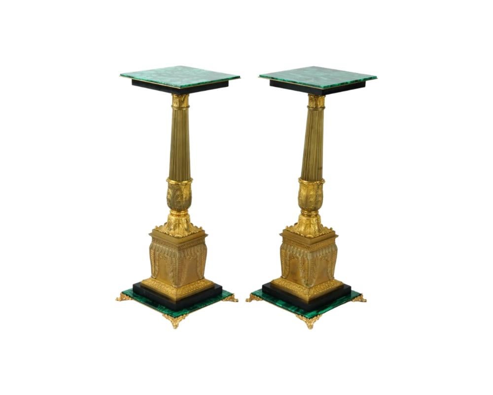 A pair of antique 19th-century French gilt bronze side tables. Footed malachite and black granite base. Corinthian column table leg on pedestal with acanthus leaf motif. Polished square malachite tabletop. Collectible Neoclassical Furniture And