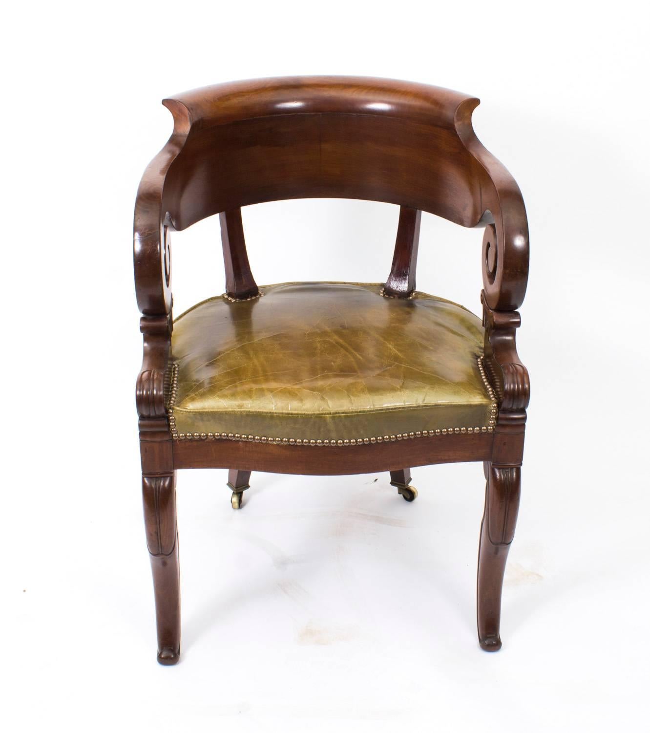 This is a spectacular Empire tub back desk chair, circa 1820 in date.

This comfortable desk chair is made of solid mahogany and has beautiful curved spiral scroll arms, with a solid curvaceous back. The seat is upholstered in a fabulous sage