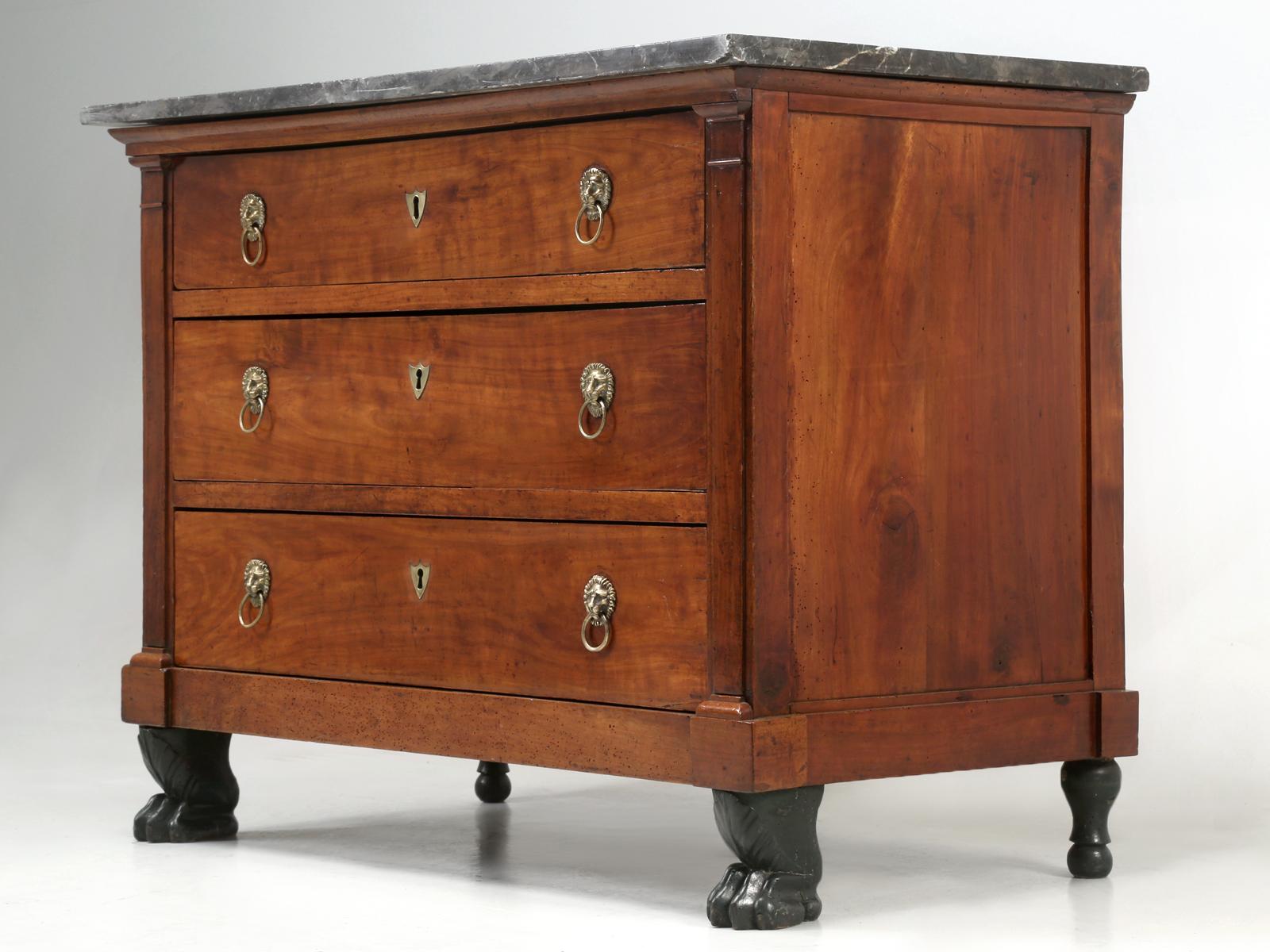Antique French Empire style commode with its original marble top. Our Old Plank restoration department completely rebuilt the drawers and the entire frame, but restrained from refinishing the mahogany. We of course enhanced the original French lion