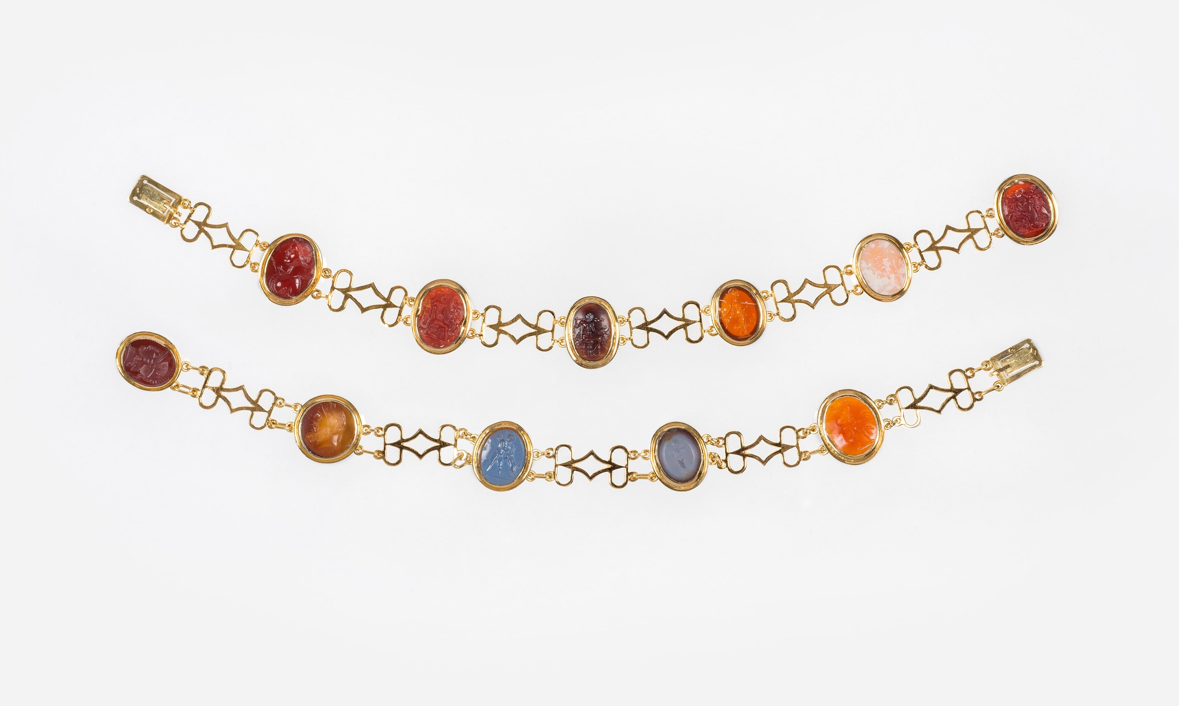 This rare and unusual pair of bracelets was hand crafted at the very beginning of the 19th century out of 18 carat gold.
The two bracelets can be joined together to be worn as a necklace.  The bracelets are set with 10 intaglios carved out of a