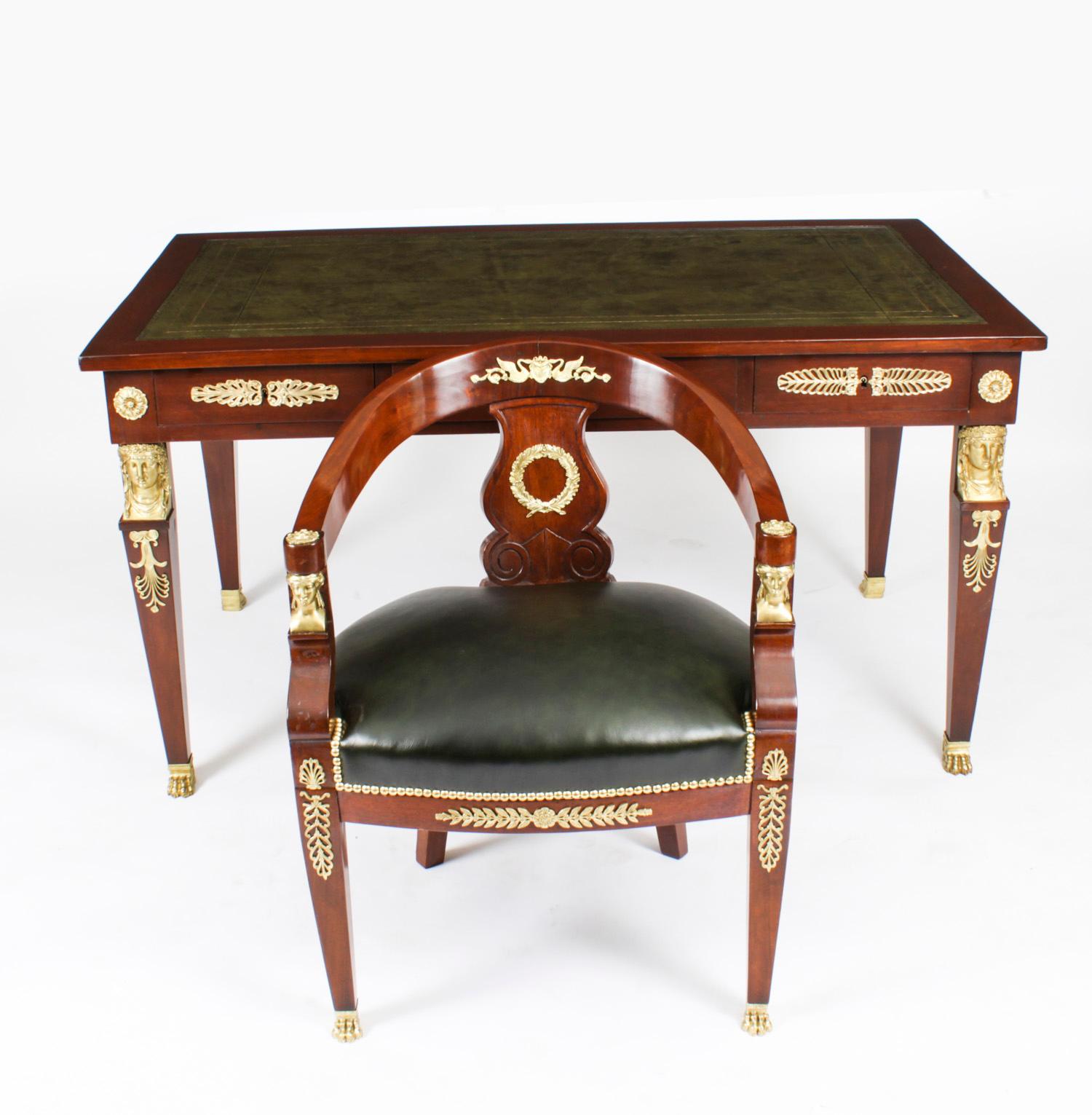 This is a fine antique French gilt-bronze mounted mahogany Empire bureau plat complete with it's original desk chair, Circa 1860 in date.
 
The rectangular top is fitted with a green gold-tooled inset leather writing surface, the frieze with three
