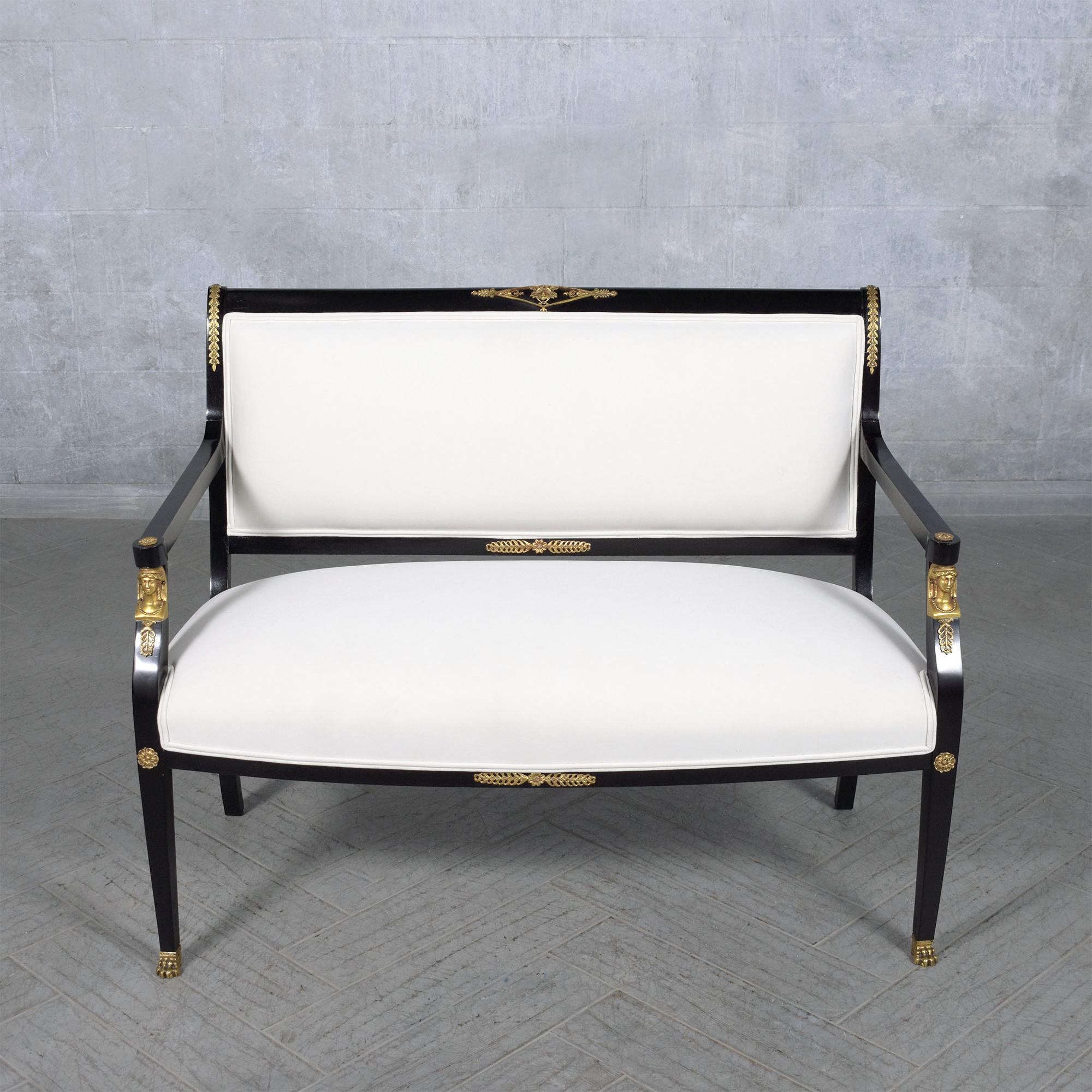 Step into unparalleled elegance with our Antique Empire Settee, a masterpiece meticulously revived by our skilled in-house team. This exceptional settee exudes classic beauty, crafted from premium mahogany wood and enhanced with a striking ebonized