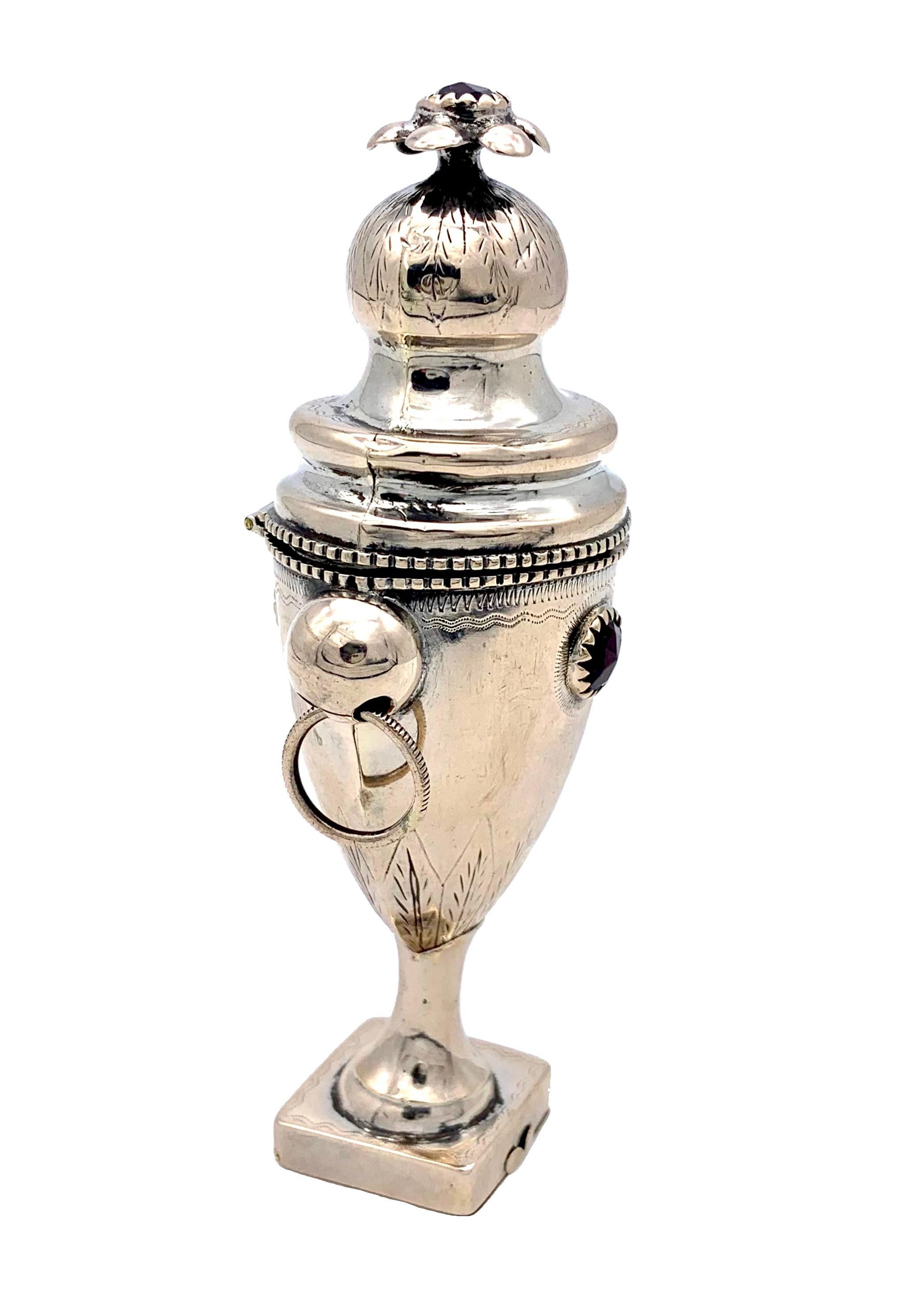 The influence of the Empire for objects in classical antique manner is still felt in this elegant silver spice box designed in the shape of an amphora on a pedestal with two handles.  The handles are decorated with a grooved pattern.. The dome