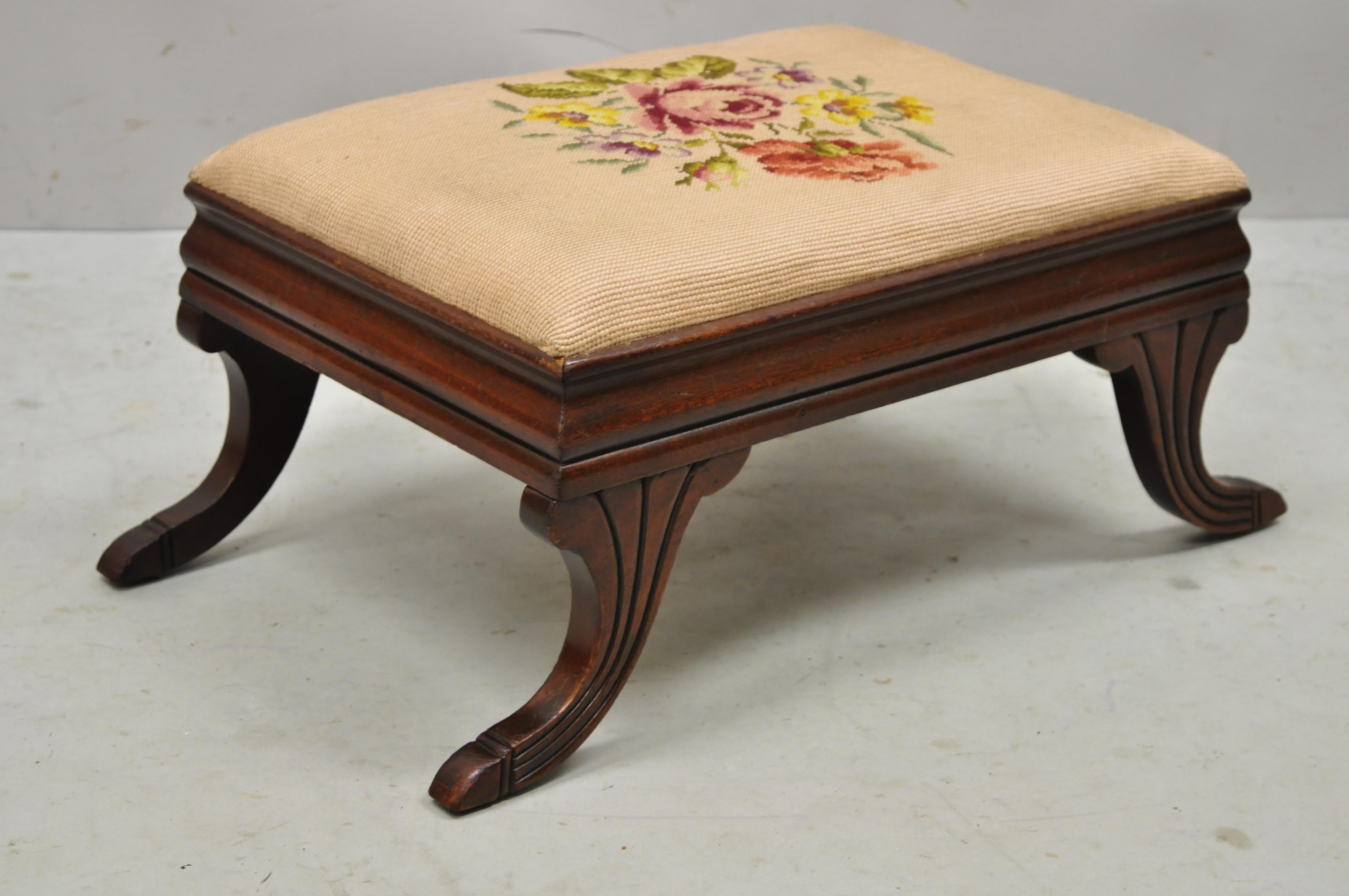 Antique American Empire Mahogany saber leg small pink needlepoint footstool ottoman. Item features shapely saber legs, pink needlepoint seat, multi-color floral print, solid mahogany wood frame, very nice antique item, great style and form. Circa